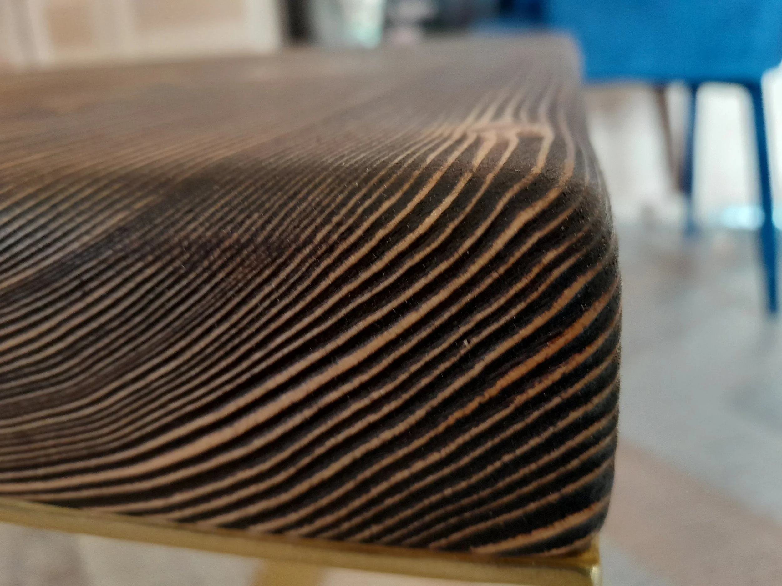 Close-up of a wooden corner with visible grain patterns and a blurred background.