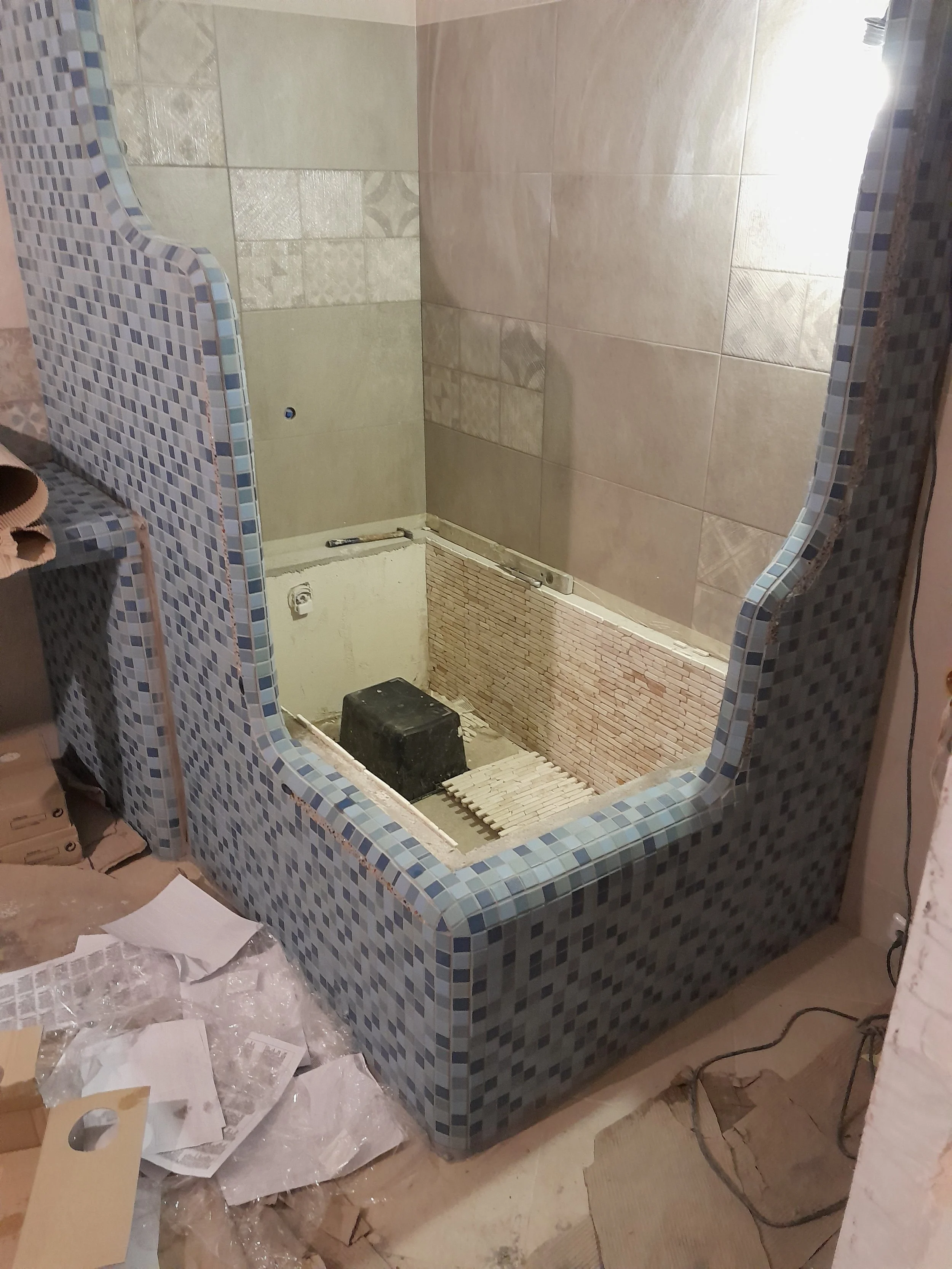 Bathroom under construction with tile installation in progress