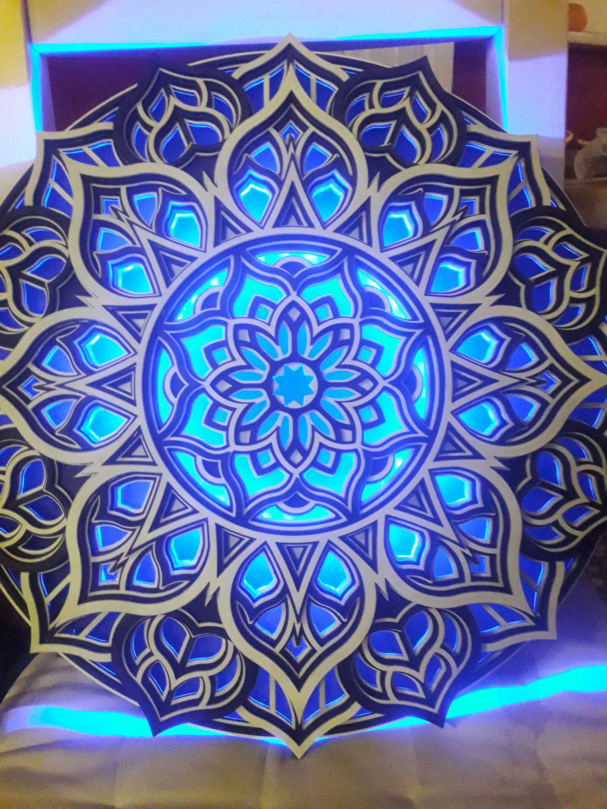 Illuminated mandala art with blue LED lights