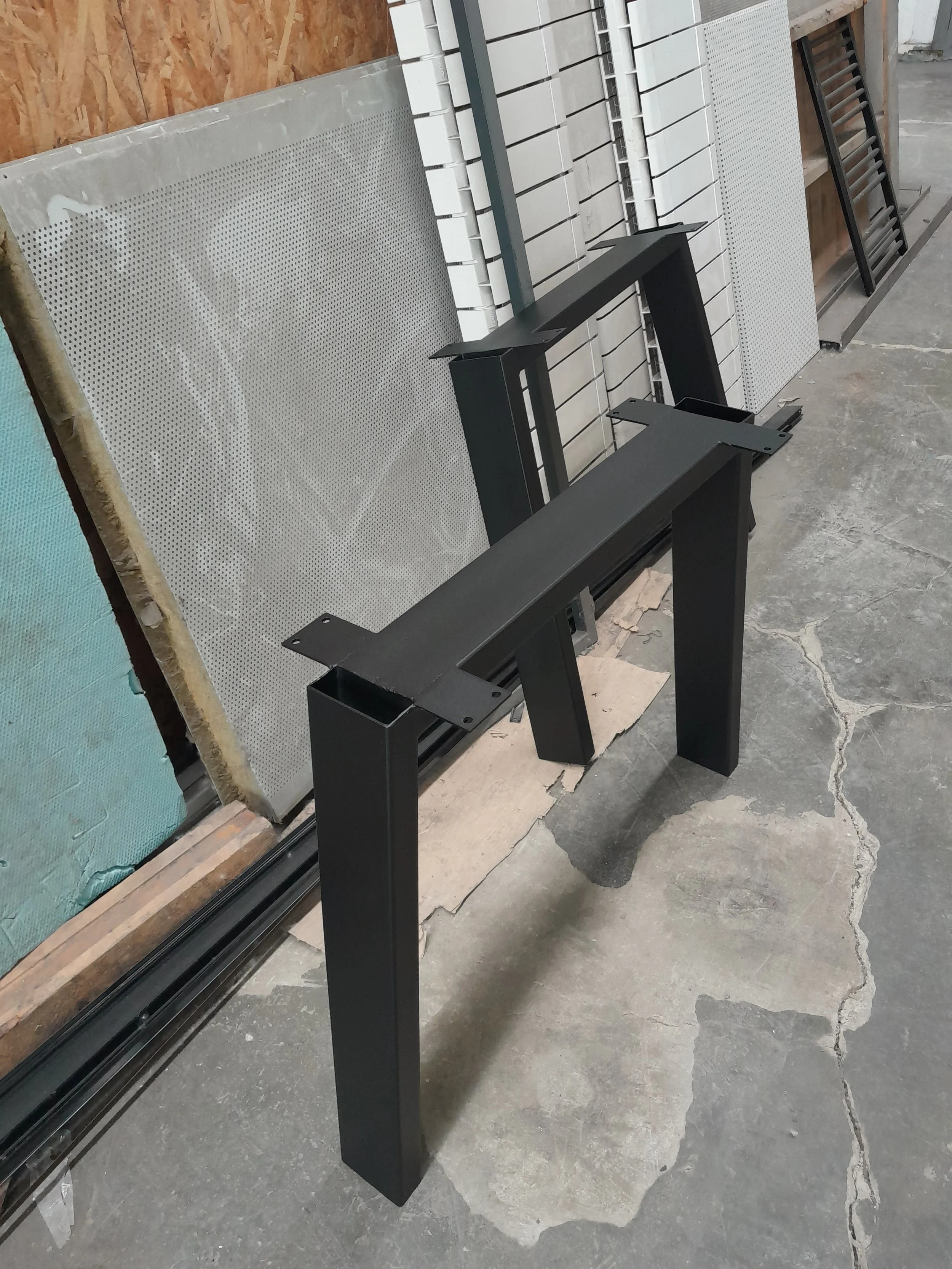 Metal table legs and panels in a workshop
