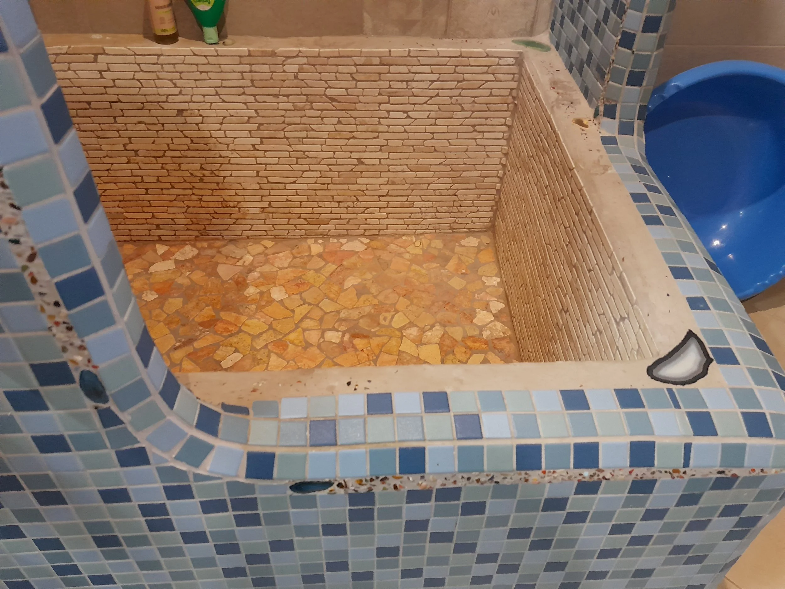 Mosaic tiled shower with blue and beige tiles