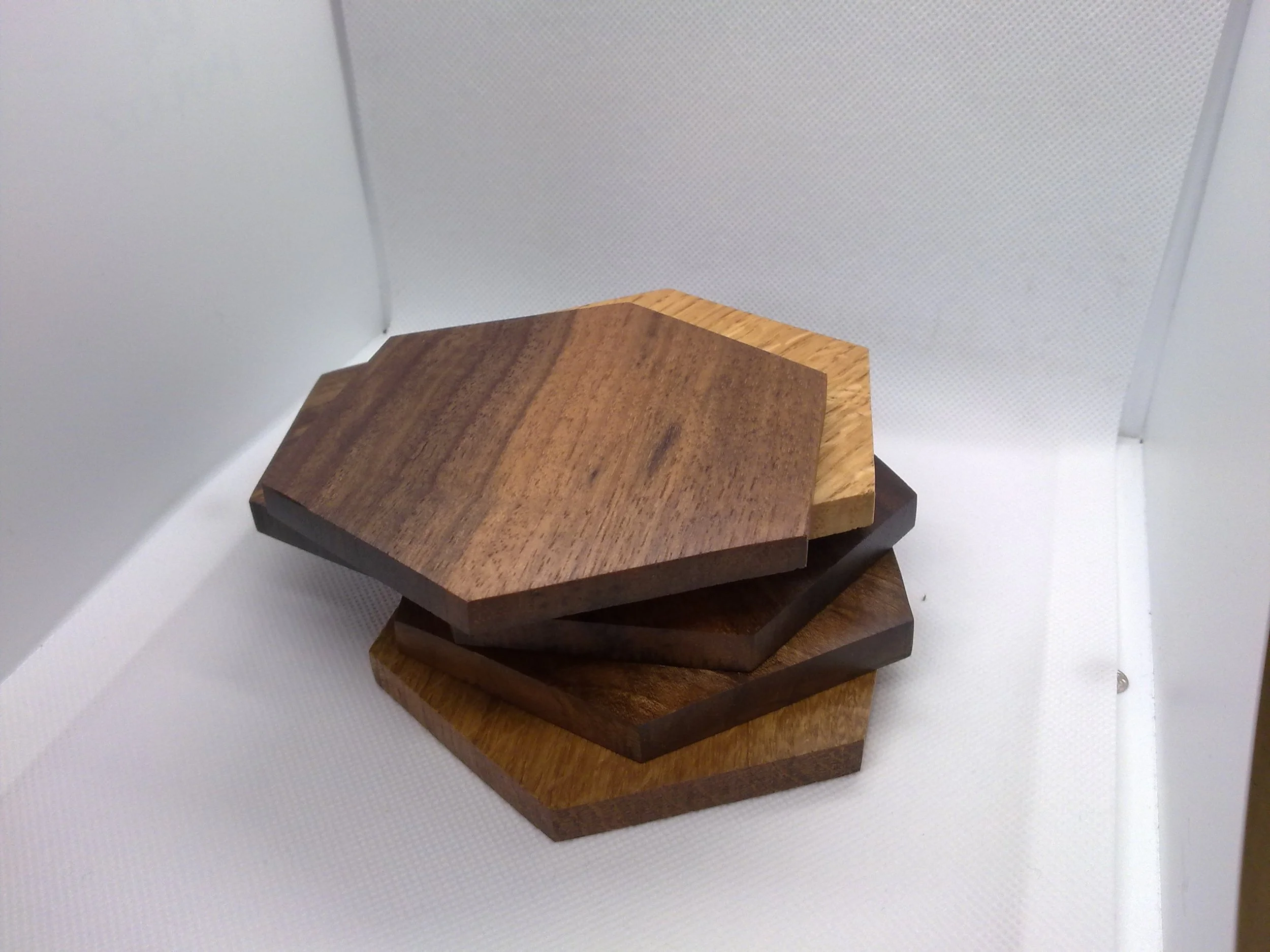 Stack of wooden coasters on a white background.