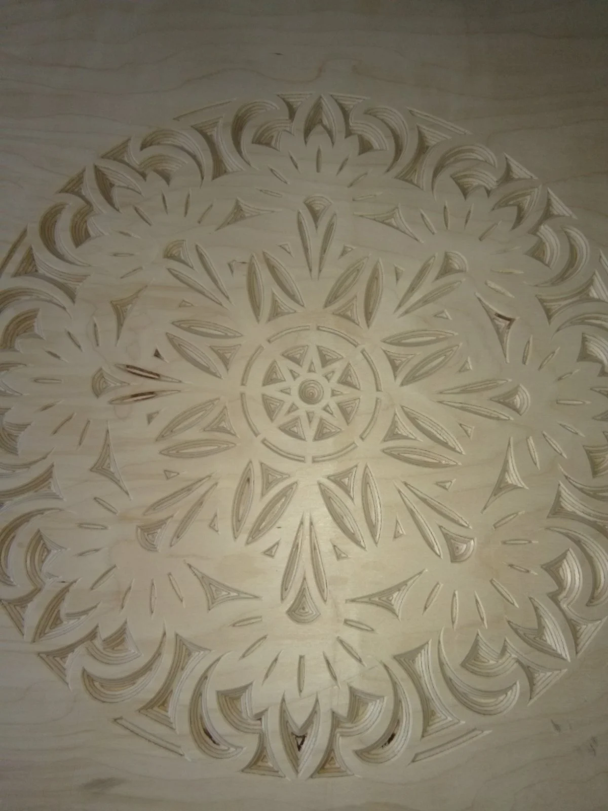 Wooden mandala engraving with intricate patterns