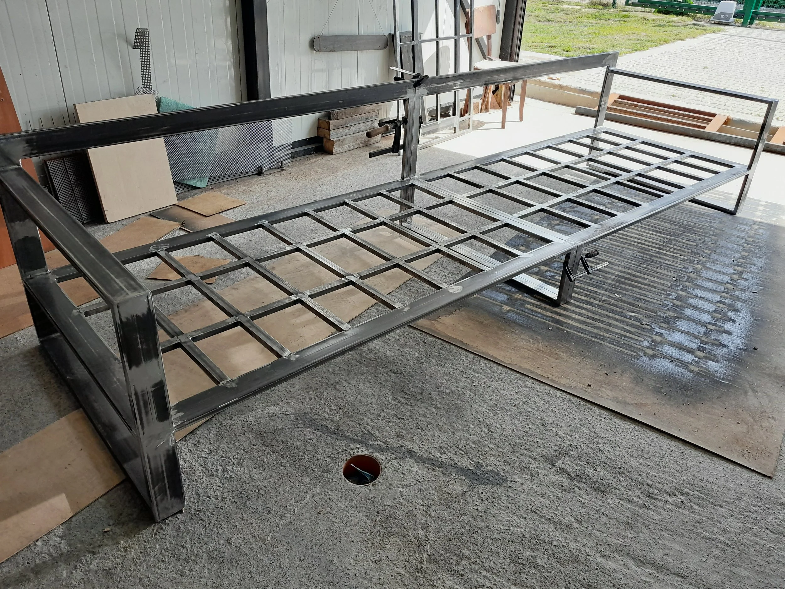 Metal frame of a bench under construction in a workshop.