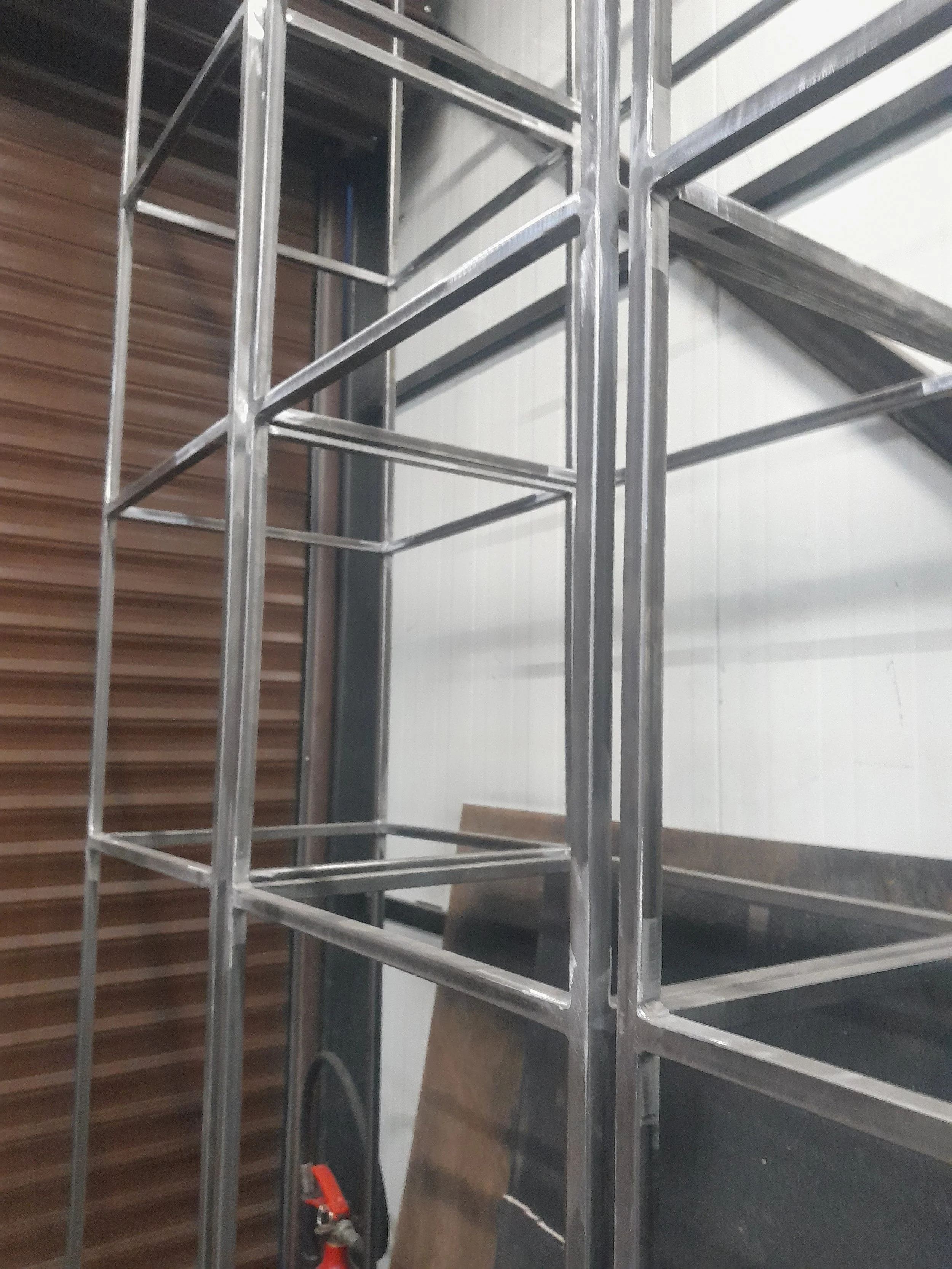 Industrial metal shelving unit frame in a warehouse setting.