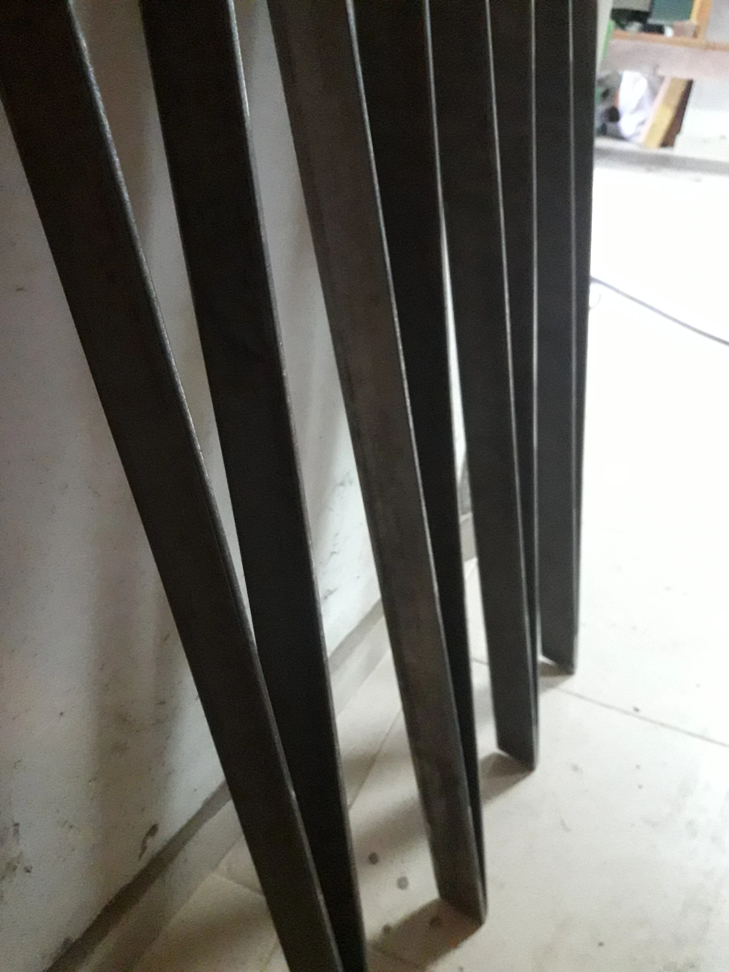 Close-up of metal rectangular bars standing upright.