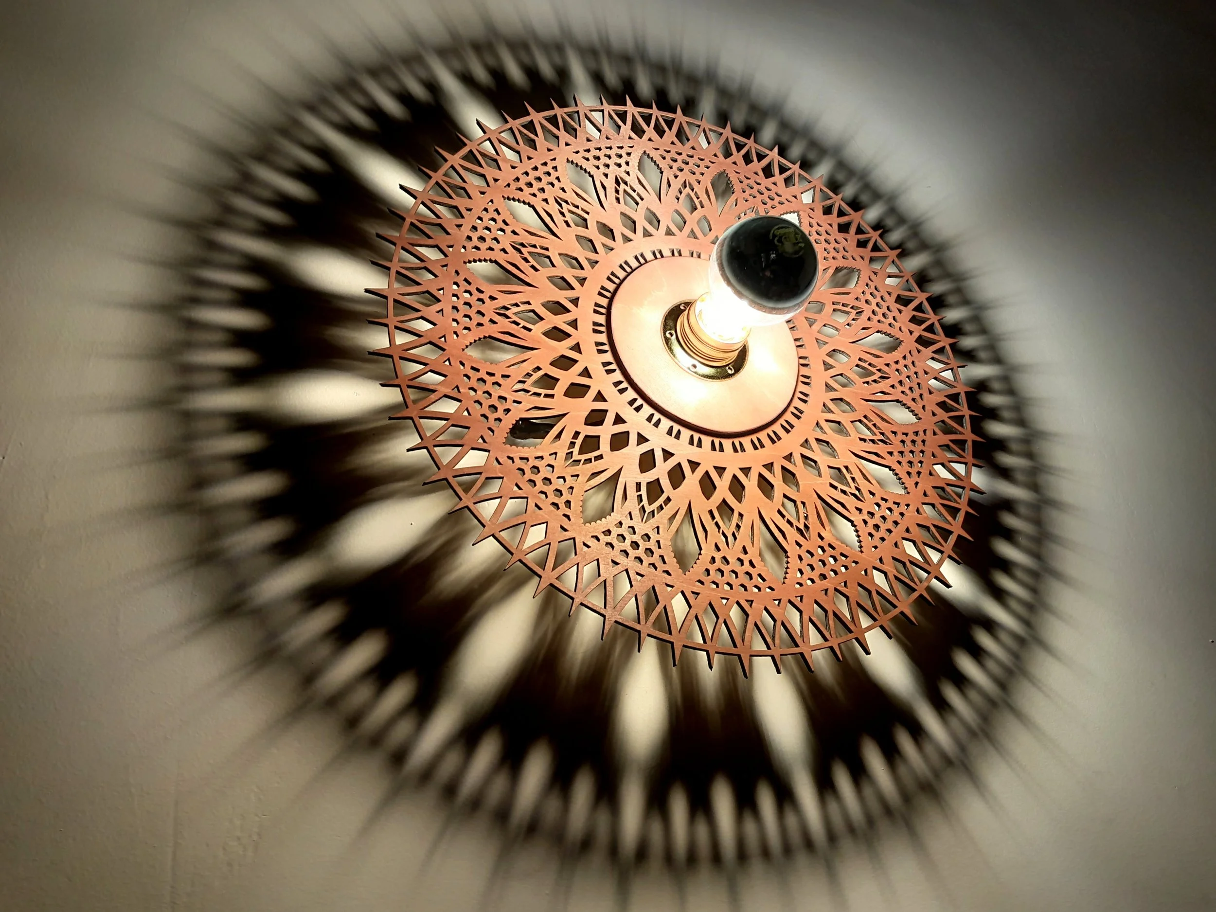 Decorative ceiling light casting intricate shadow patterns