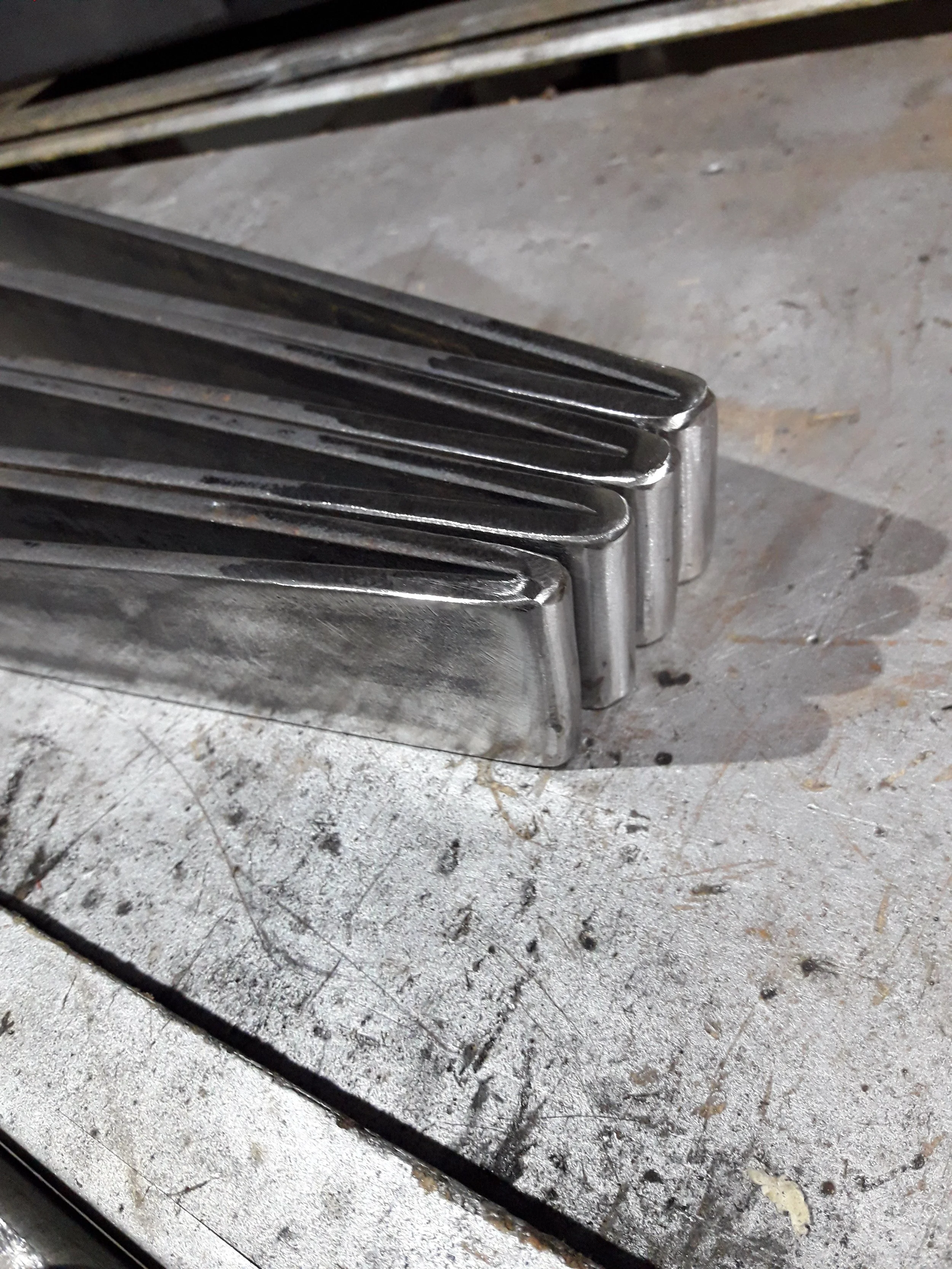 Stacked metal pieces on a scratched metal surface