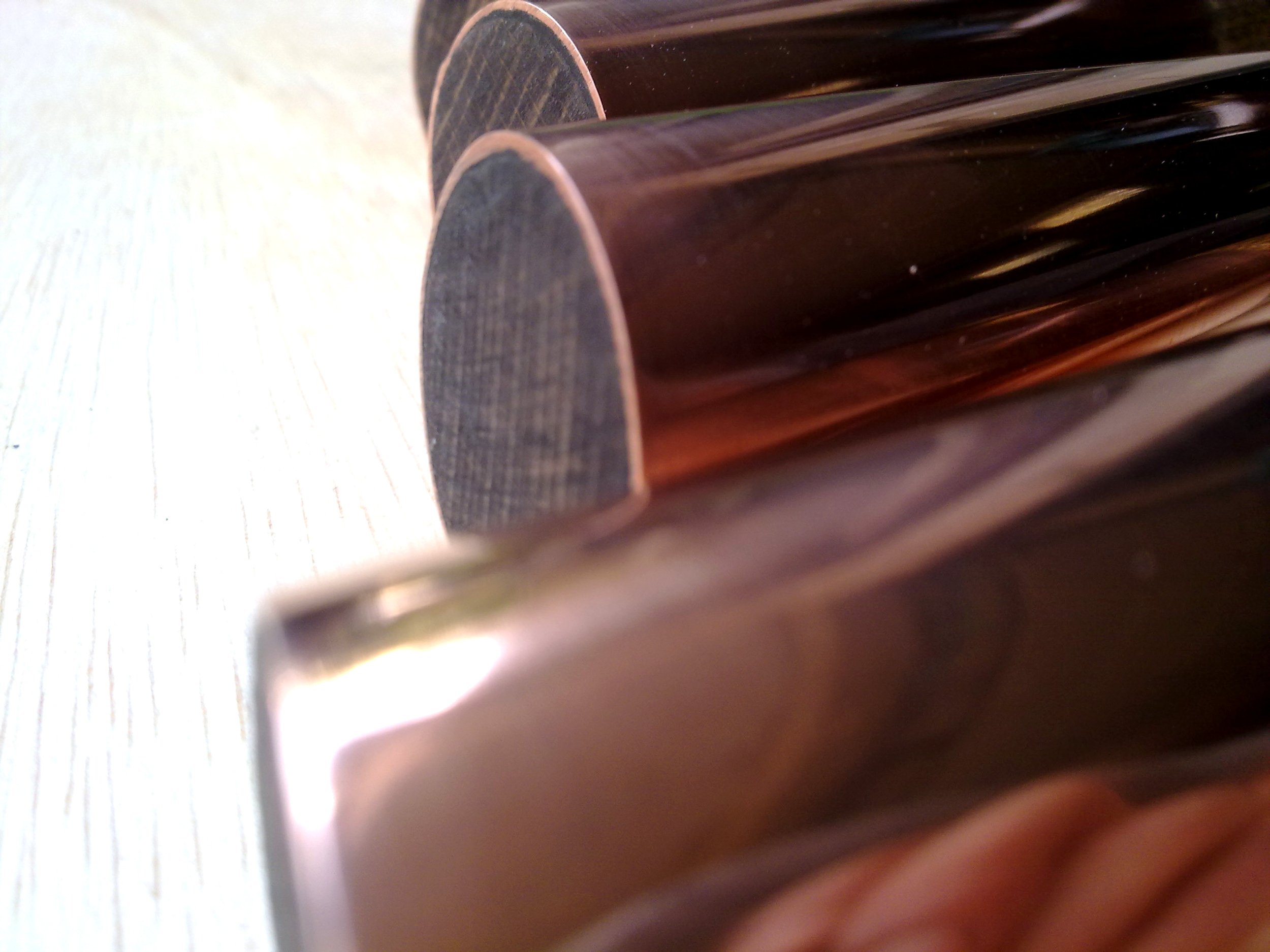 Close-up view of copper pipes with reflective surface
