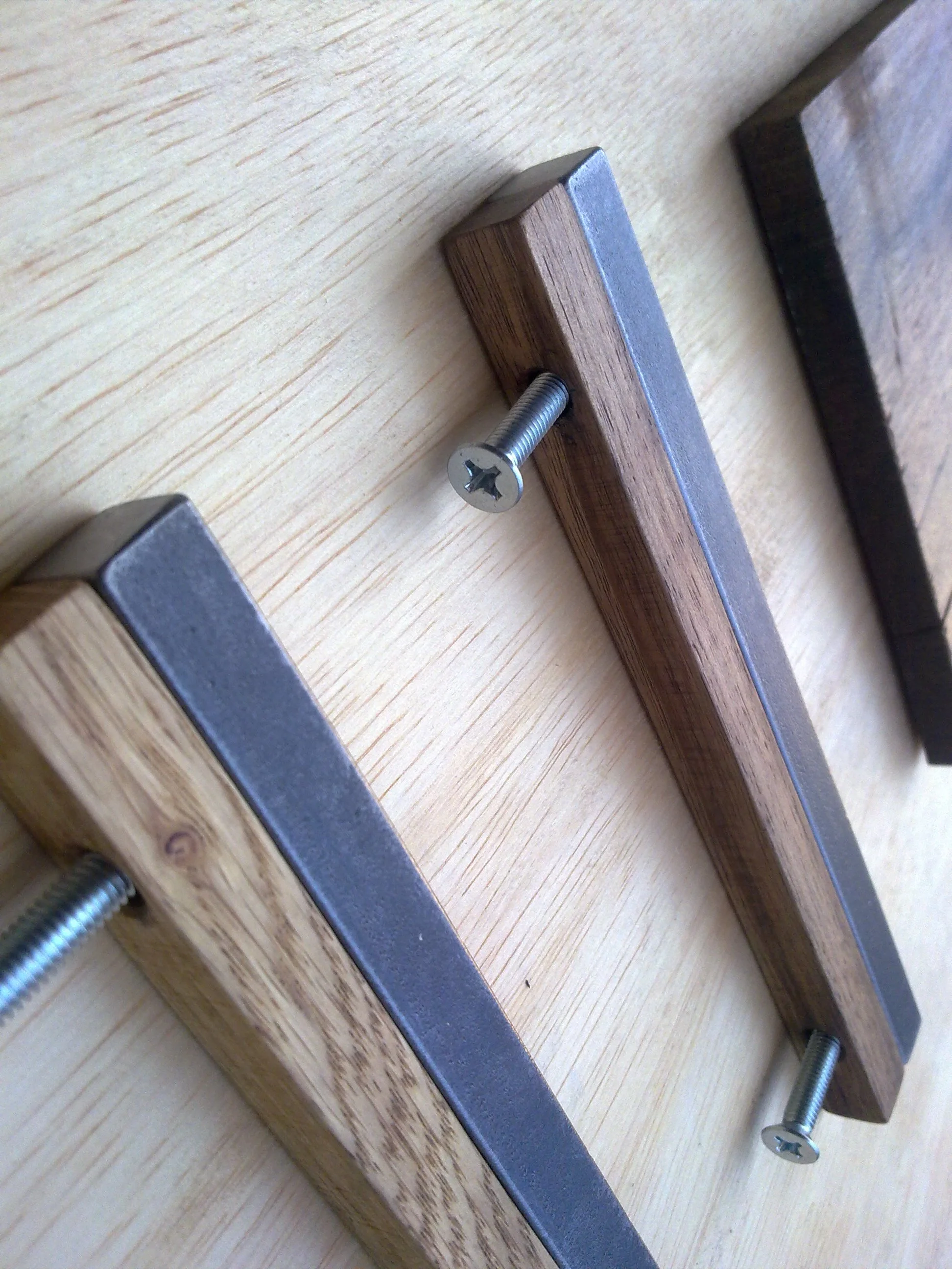Close-up of wooden and metal handles with screws