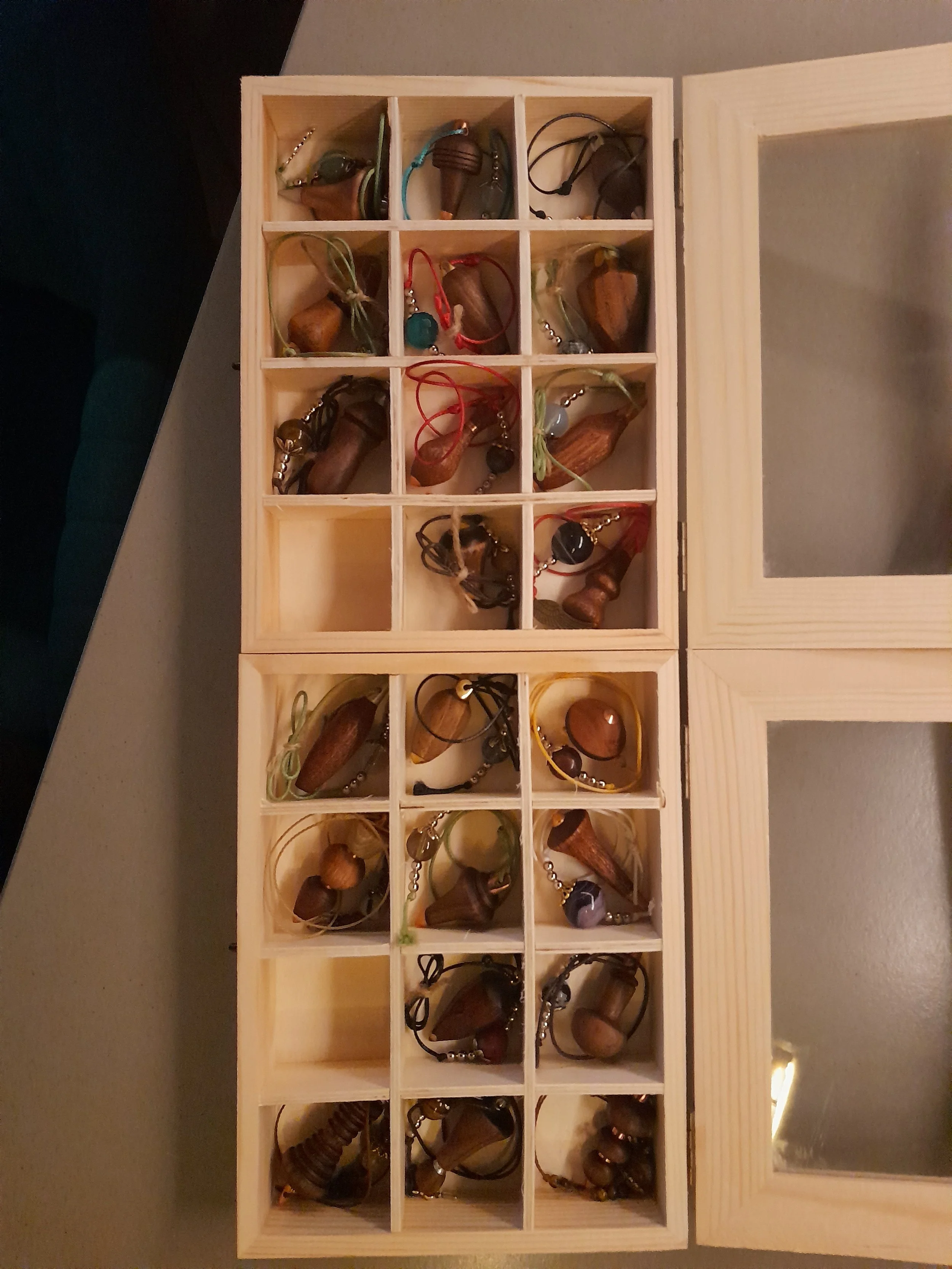 Wooden jewelry box with assorted necklaces and pendants