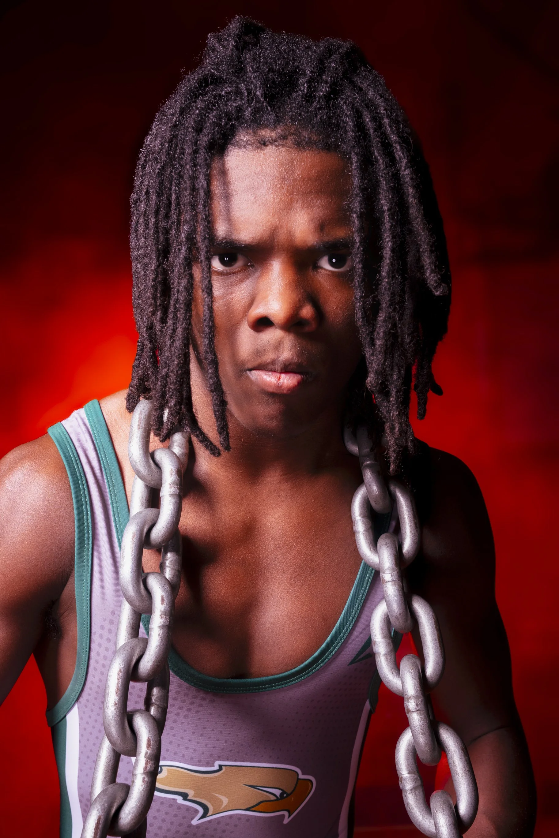 Wrestler portrait by New Hampshire sports photographer with chains and dramatic studio lighting