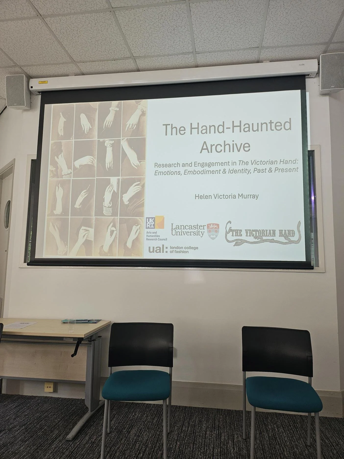 The Hand-Haunted Archive title slide onscreen at the conference.