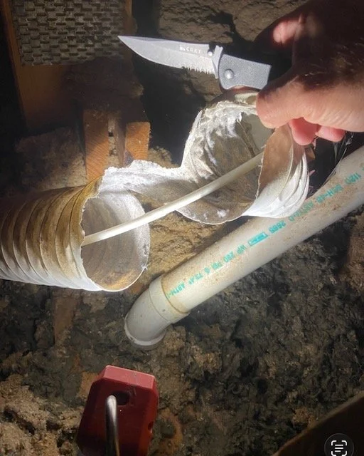 Old Plastic ducting used to route dryer exhaust in the attic and a customer's lint brush stuck inside-rigid all metal duct is required by code