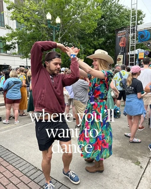 Darley Newman joins a festival goer for an impromptu dance on the street.