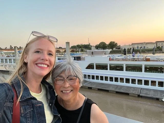 On the banks of the Garonne in Bordeaux, Darley and Evelyn capture a “Travels with G-Ma” moment during filming for Uniworld’s Brilliant Bordeaux river cruise.