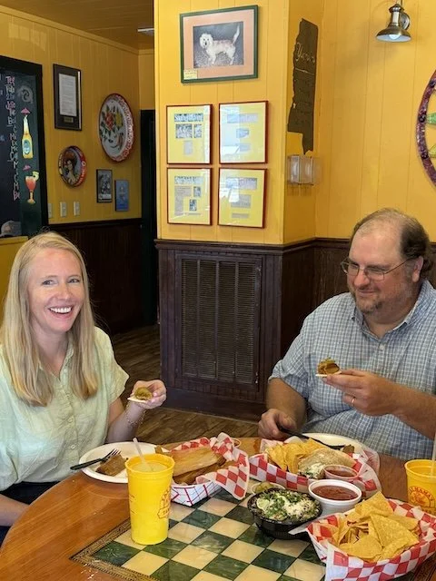 Darley Newman with owner, David Gammill at Fat Mama’s Tamales, digging into tamales and sipping the restaurant’s famously strong Knock-You-Naked Margaritas.