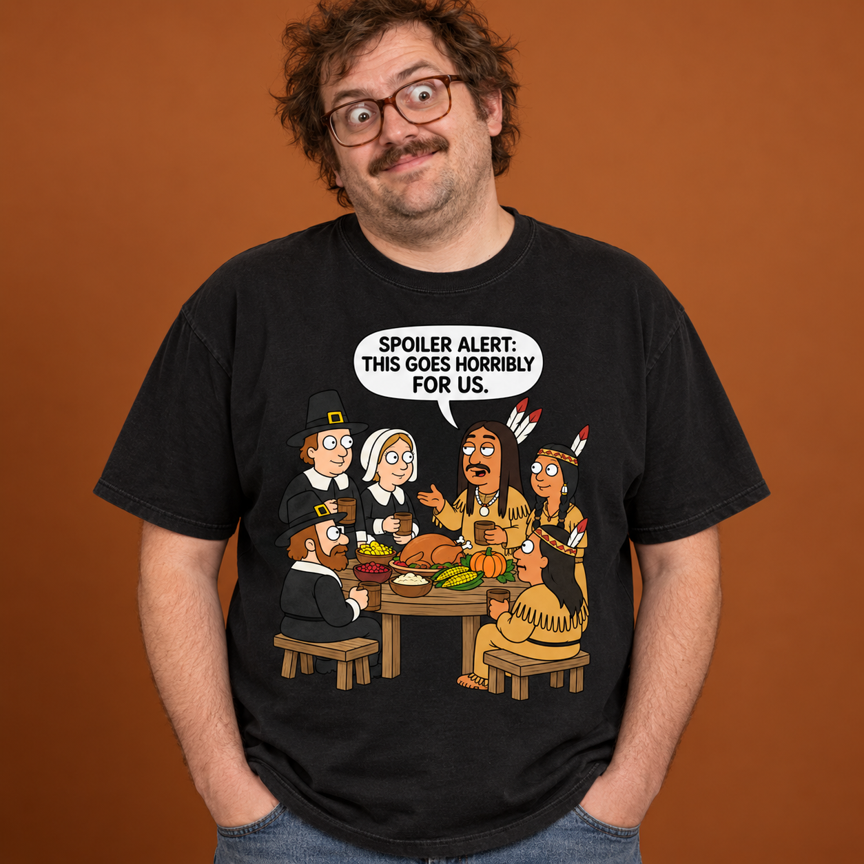 Awkward model wearing a black Comfort Colors 1717 T-shirt featuring the FuHoSh Spoiler Alert first Thanksgiving cartoon design.