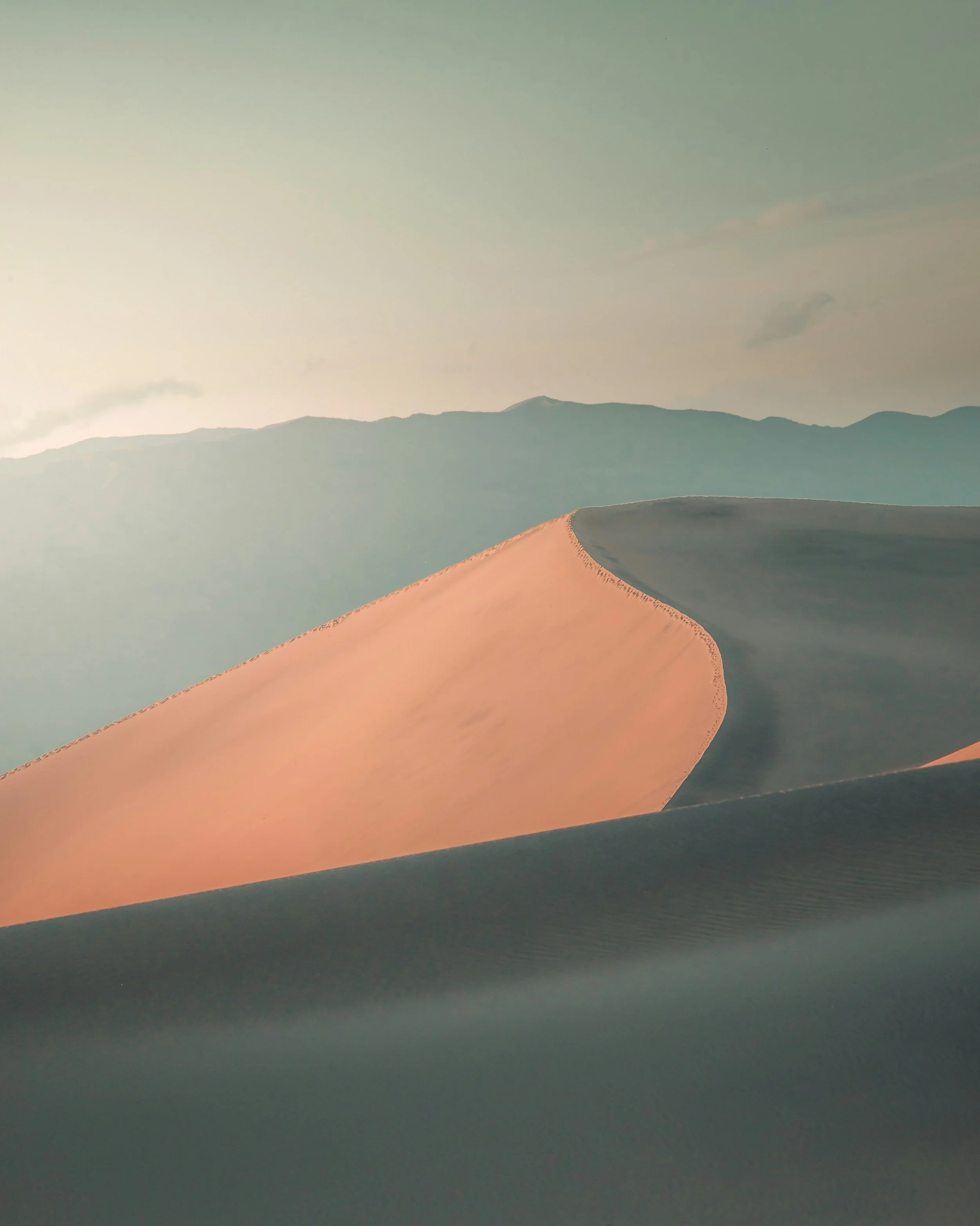 A desert sand dune with a steep incline, reflecting the effort of moving forward when energy is limited