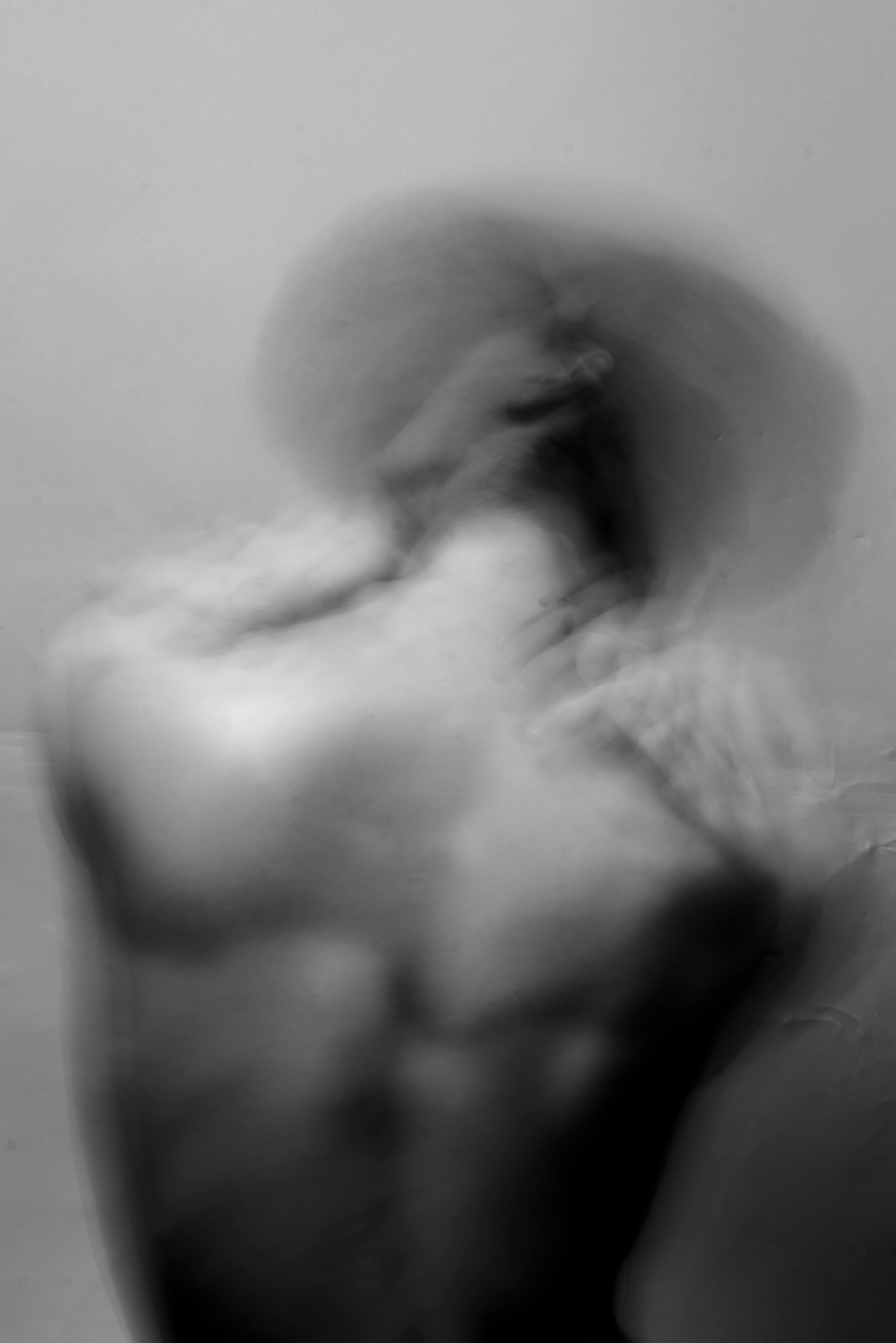Blurred black-and-white image of a human body in motion, suggesting how the nervous system and immune system hold implicit memory from early experiences.