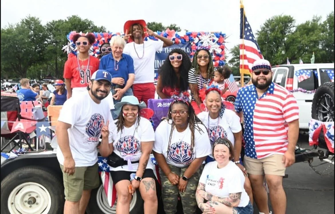 A large group of Helen's Project staff and community members together at an outdoor community event