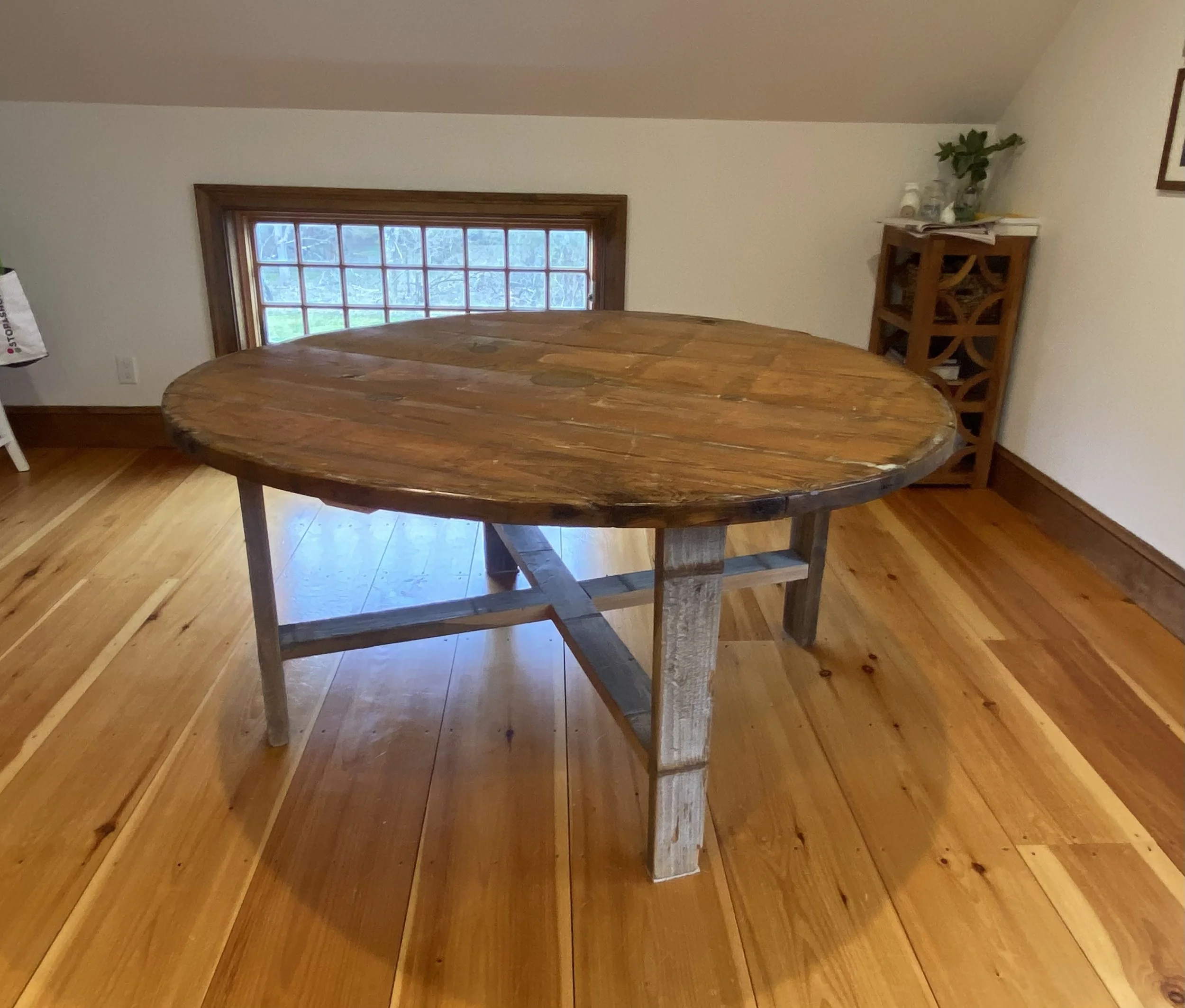 Circular dining table handcrafted on Long Island using reclaimed 100-year-old water tower wood