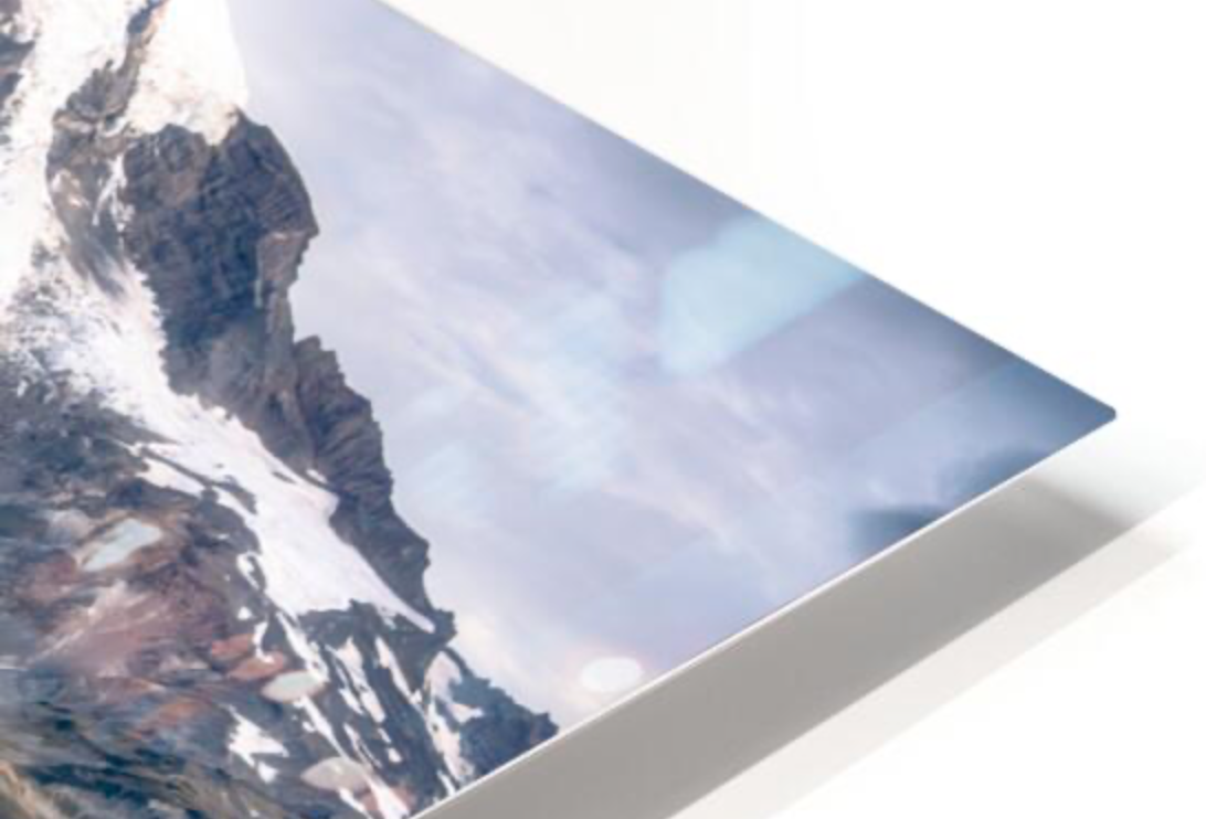 Close-up of a canvas print of a mountain landscape with snow and rocks, partially rolled at the corner.