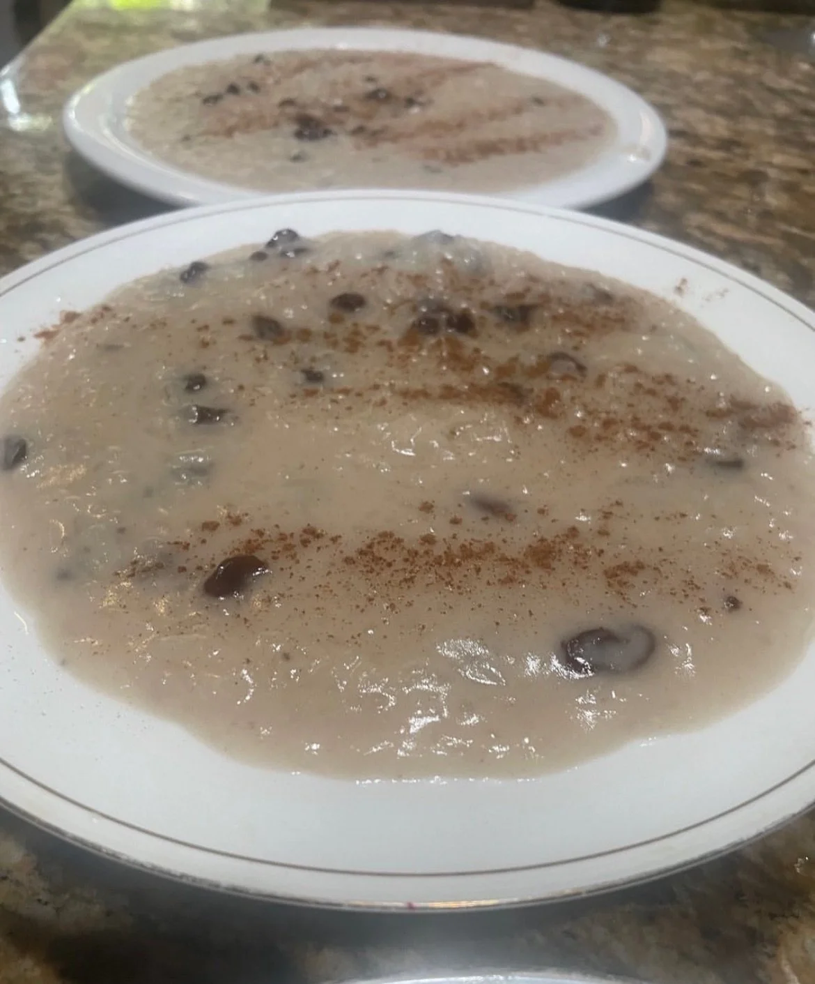 dos platos de arroz con dulce espolvoreados con canela.