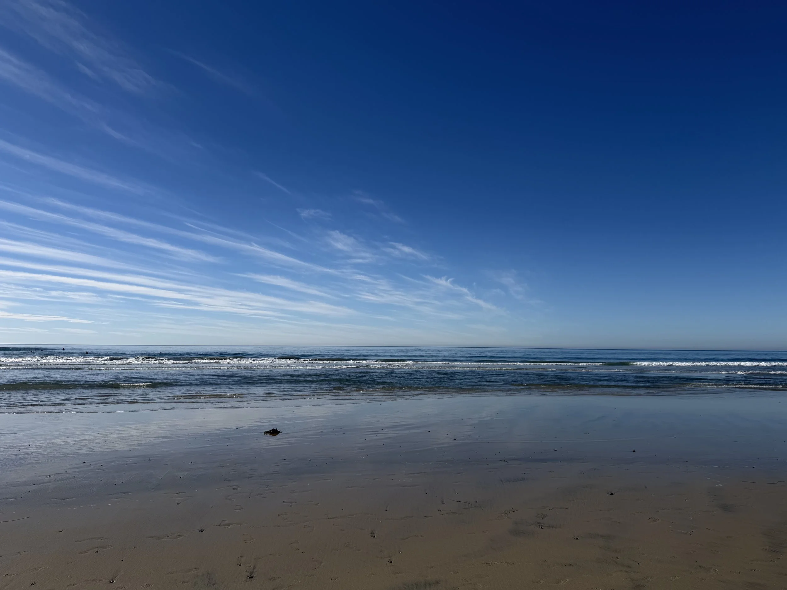 Beach scene with clear blue sky and gentle waves labeled “Coaching” — representing Ilene Schaffer’s calm, forward-focused support for women navigating life transitions.