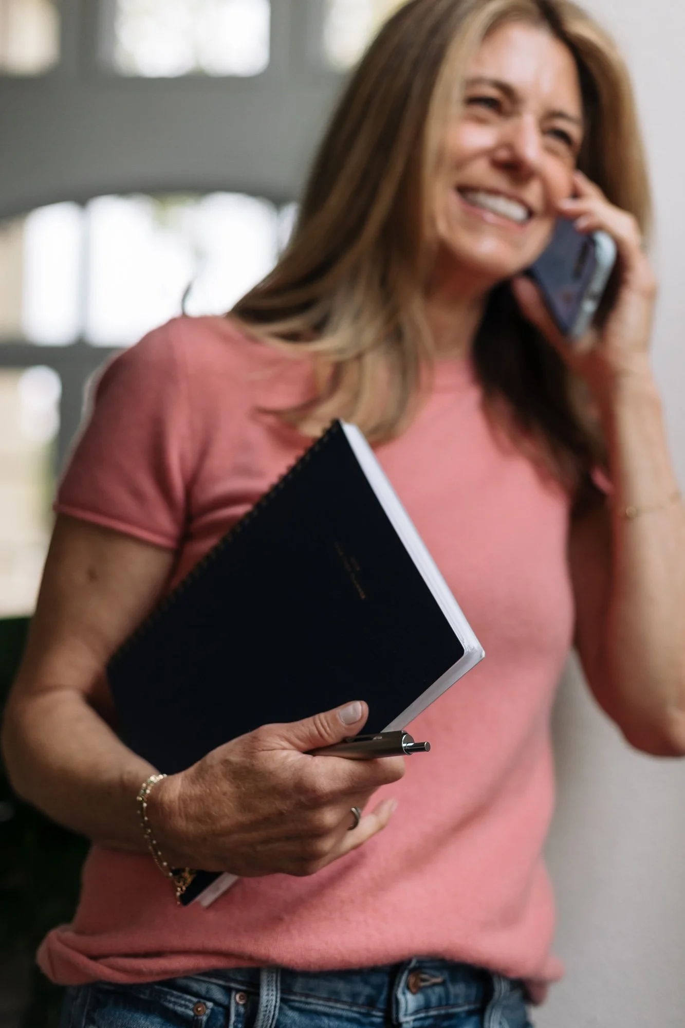 Person holding a 2023 planner and talking on the phone — representing Ilene Schaffer’s coaching approach to intentional planning, personal growth, and mindful productivity.