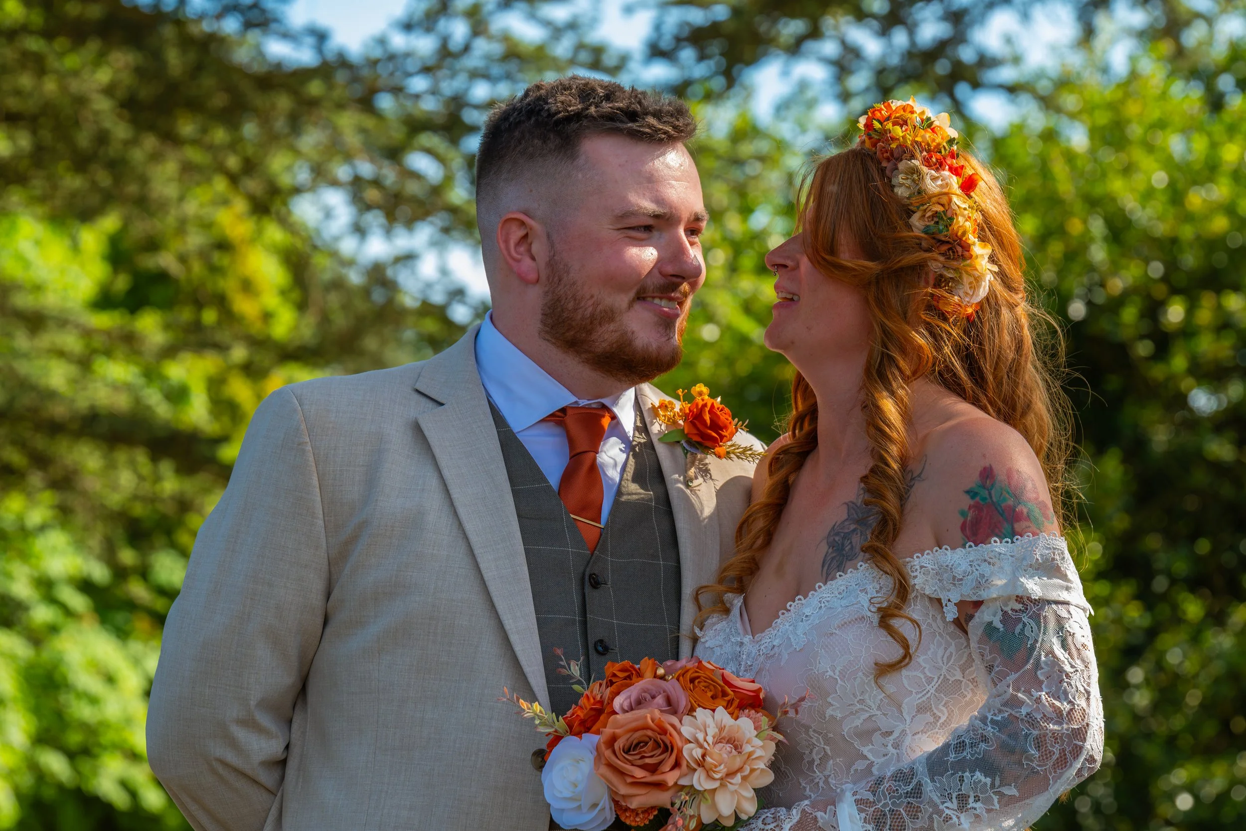 Natural wedding portrait of the bride and groom sharing a moment together outdoors.