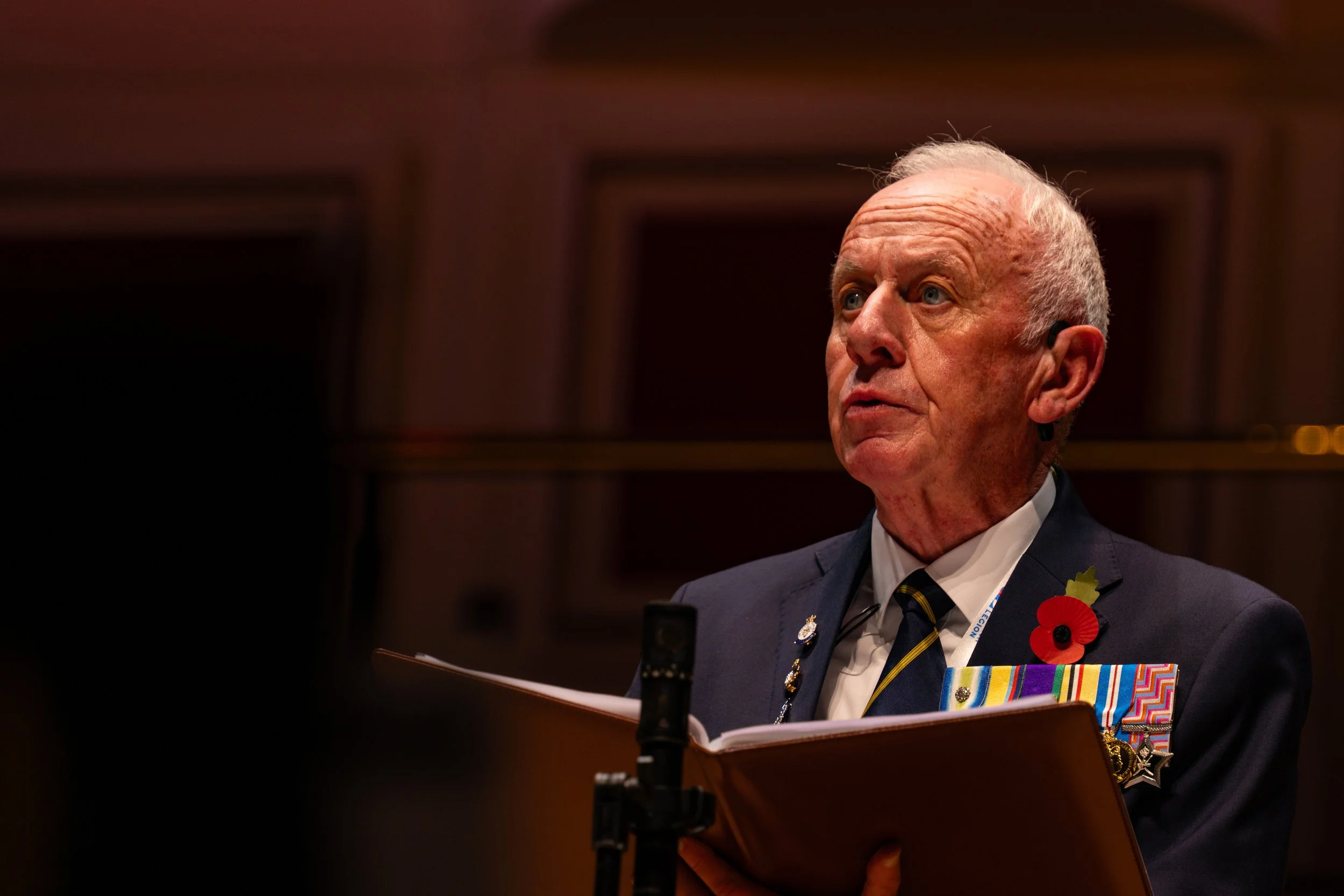 Event photography of a speaker addressing guests during a live presentation.
