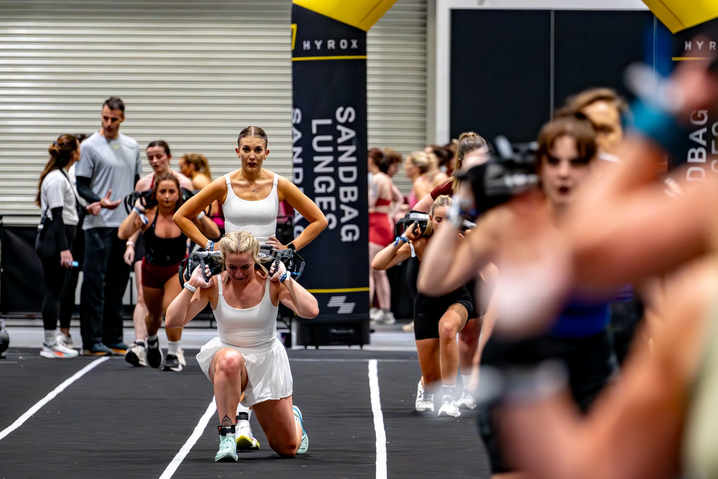 Professional event photography of an athlete competing on the track during a HYROX fitness event.