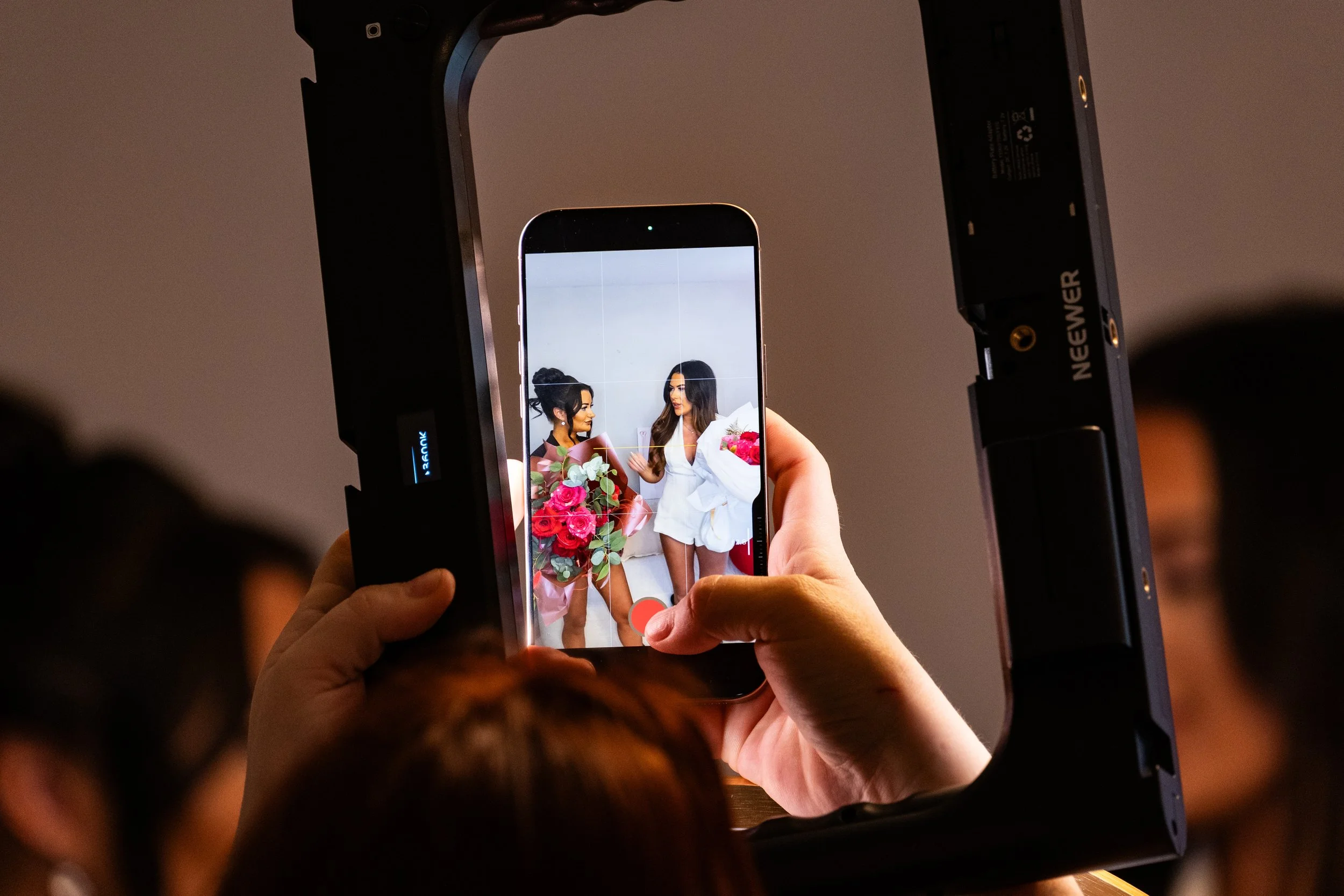 Candid event photography of guests enjoying a social event in a studio setting.
