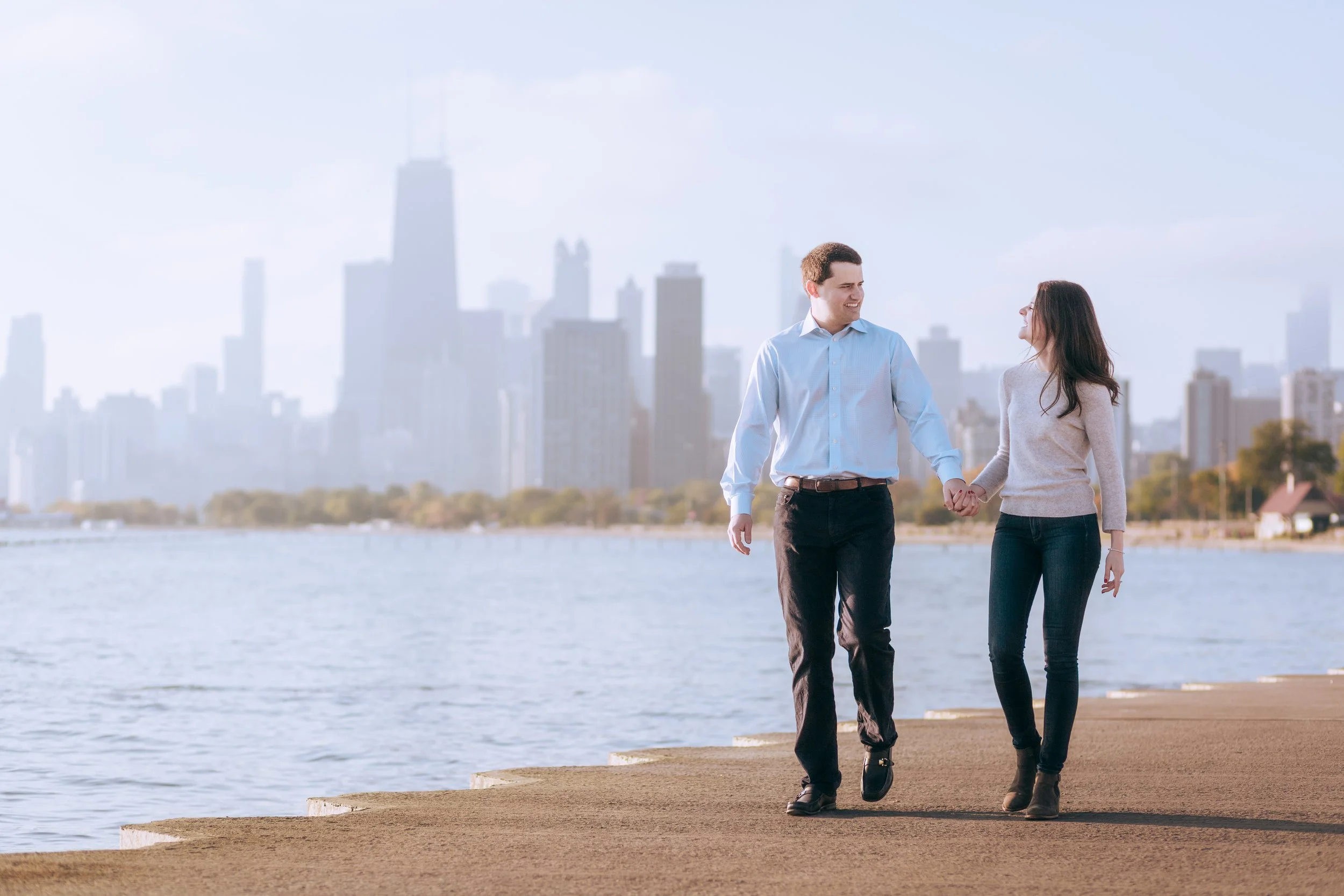 Couple laughing and walking on the Chicago Lakefront in Lincoln Park