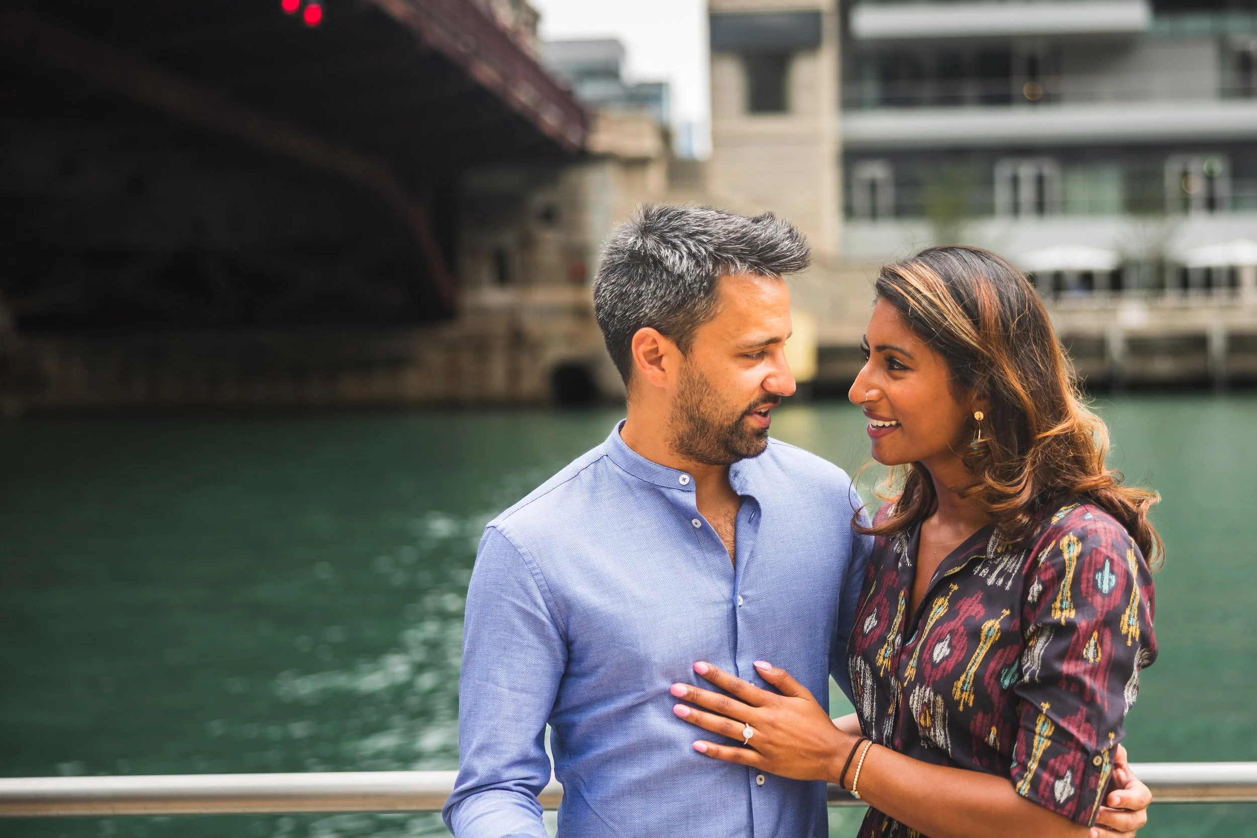 Couple embracing under the skyline on the Chicago Riverwalk
