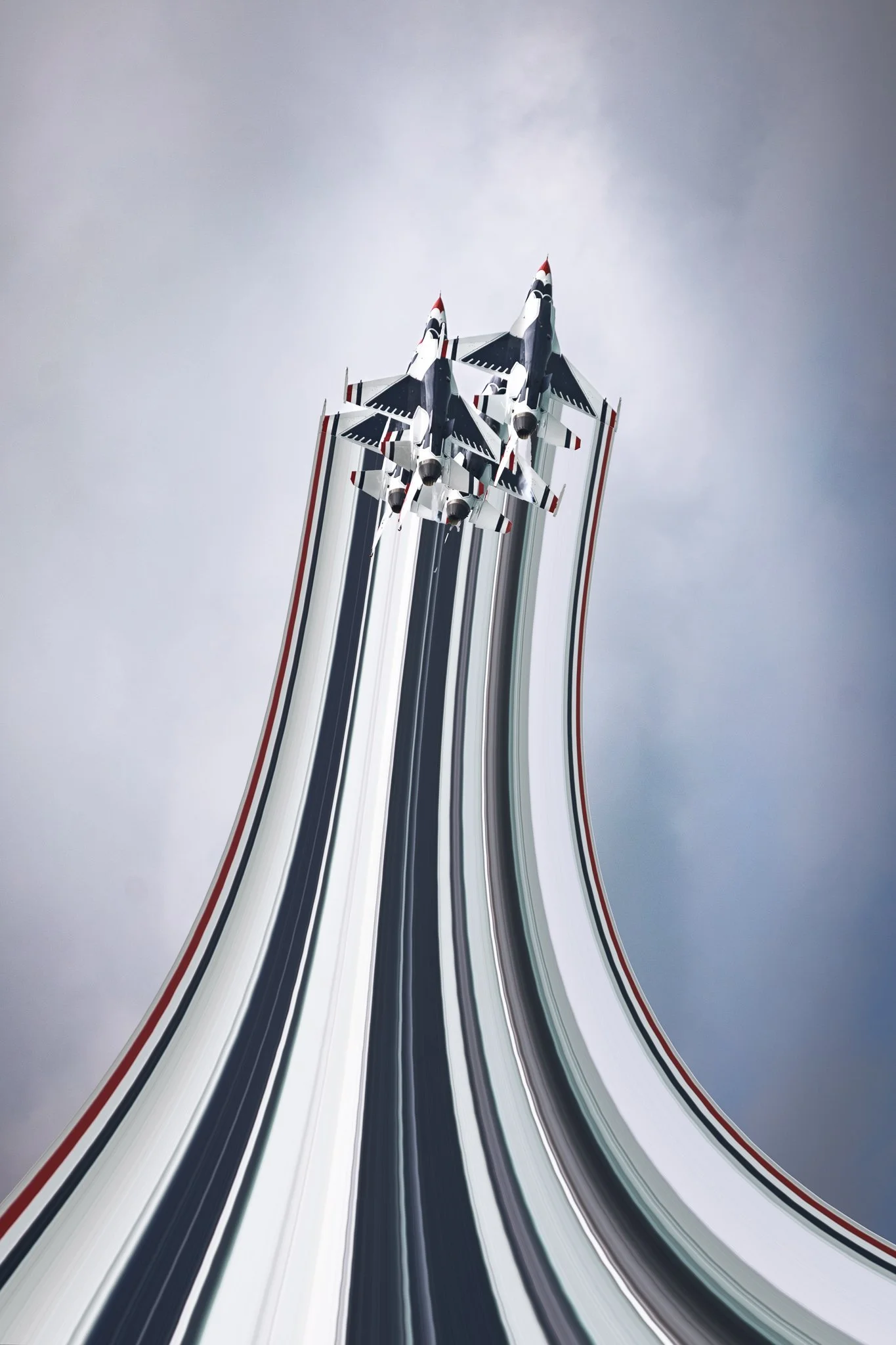 Three fighter jets flying in formation with visual trails against a cloudy sky.