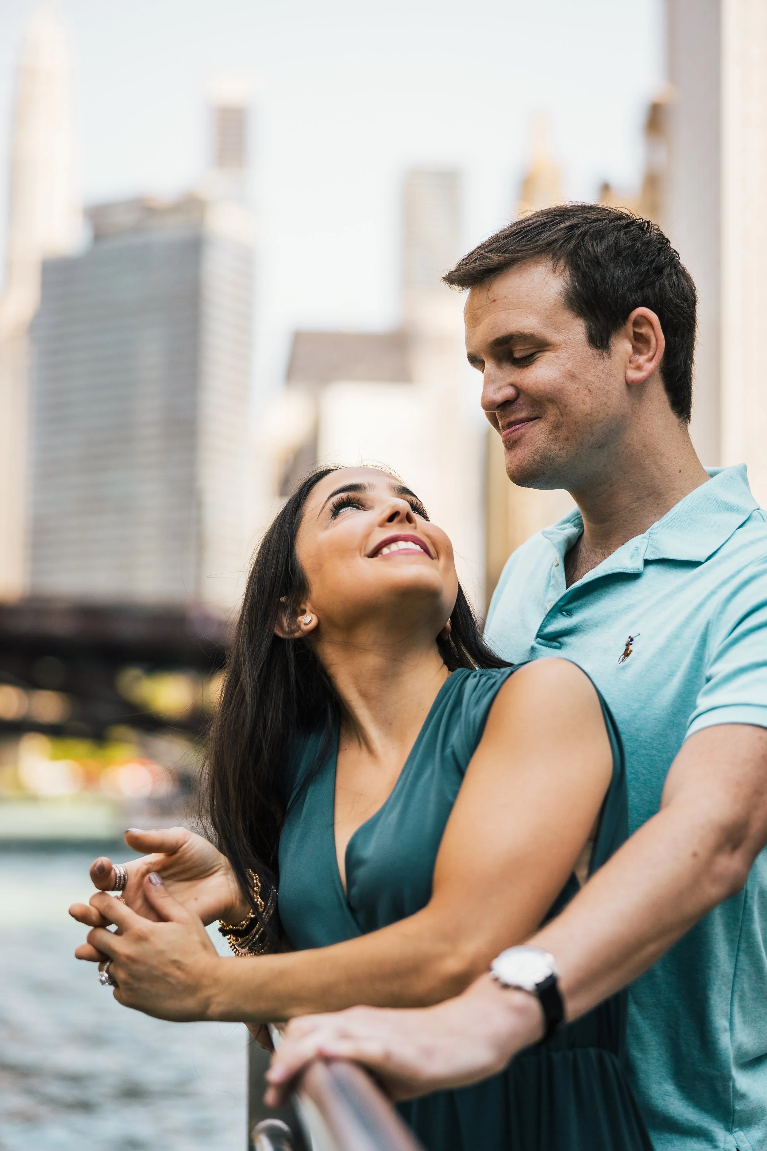 Couple embracing in front of the skyline on the Chicago Riverwalk