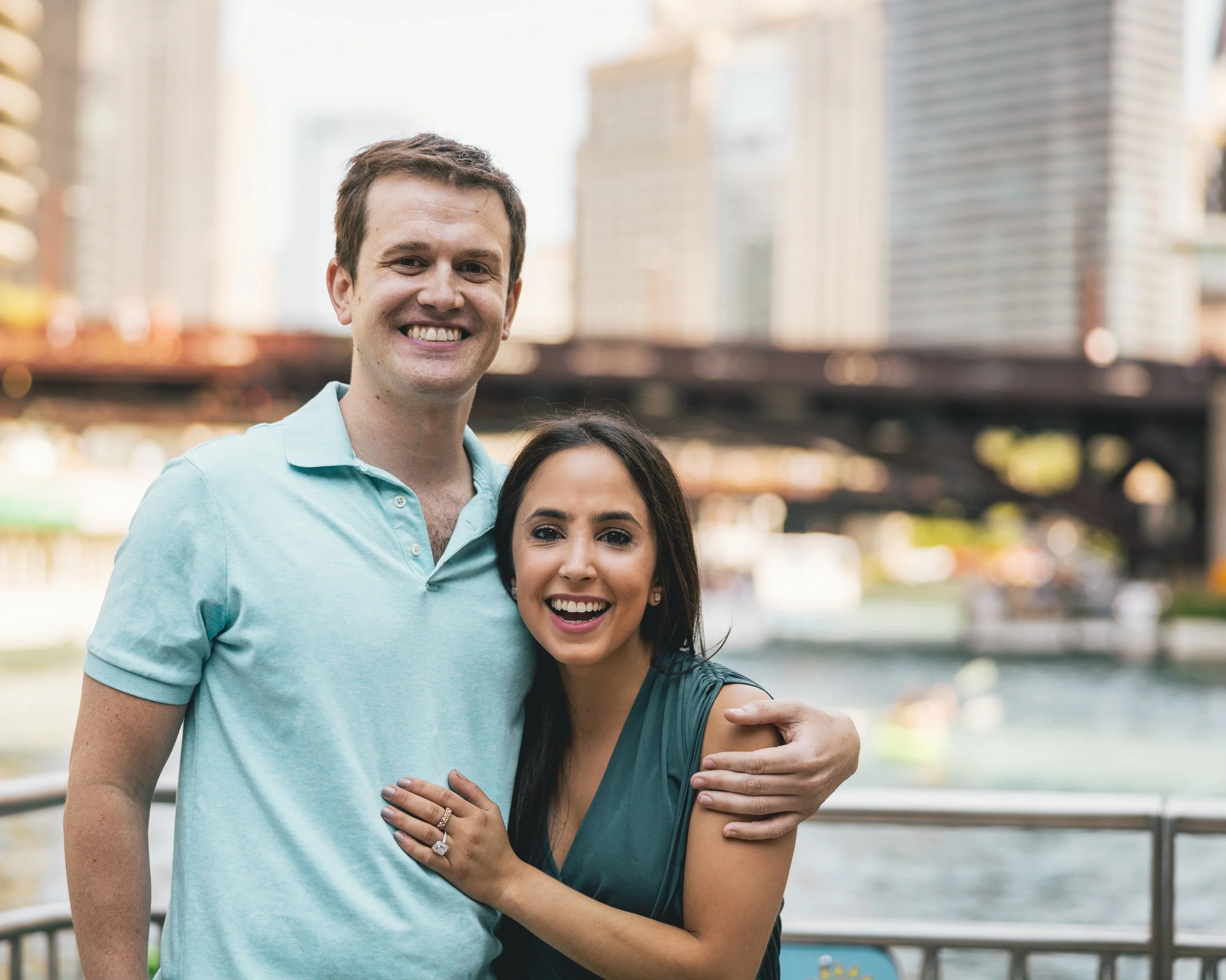 Couple embracing in front of the skyline on the Chicago Riverwalk