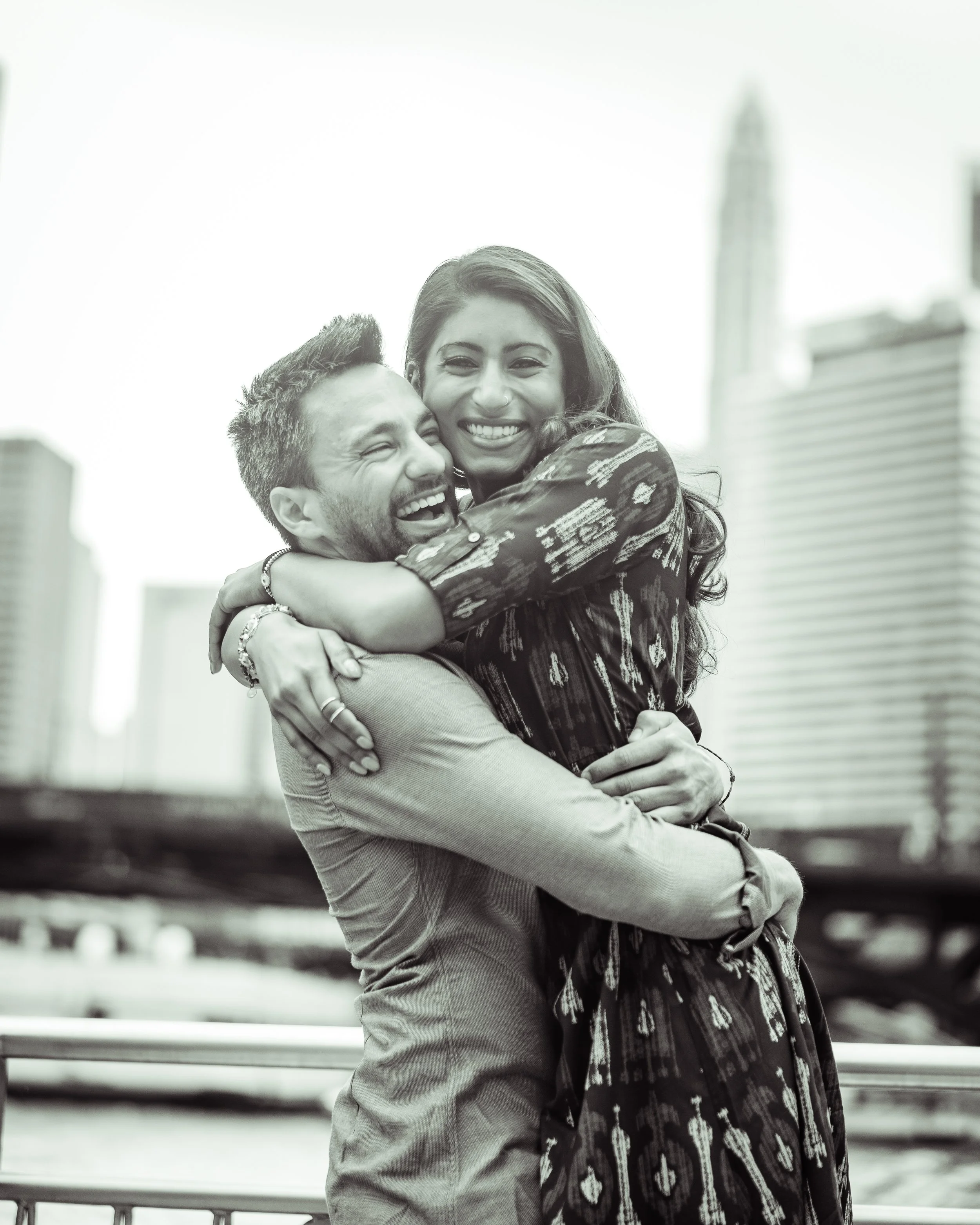 Couple embracing in front of the skyline on the Chicago Riverwalk