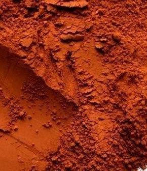 Close-up of red-brown powder with a textured surface.