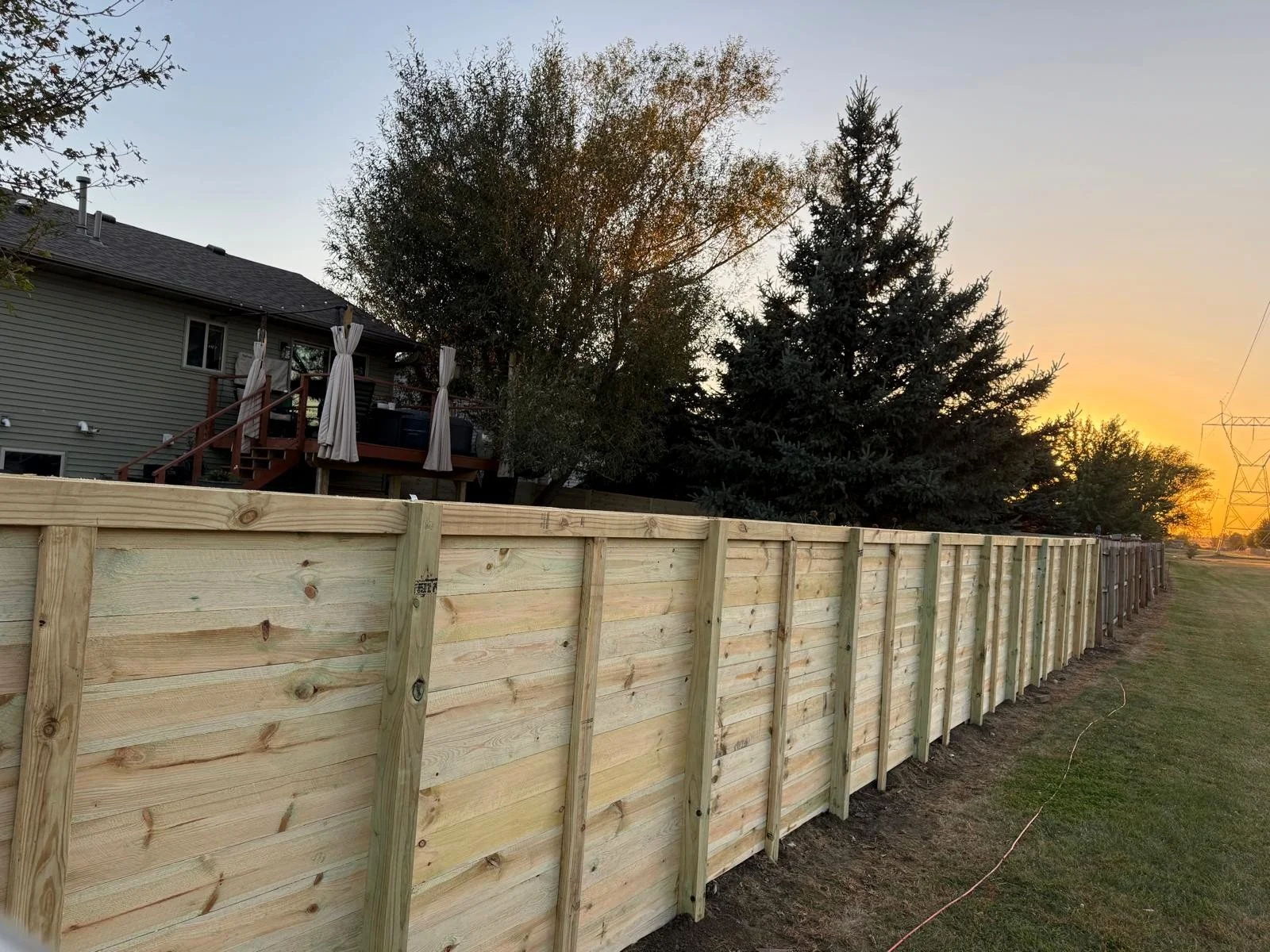 Beautiful horizontal privacy fence at sunset in Sioux Falls neighborhood.