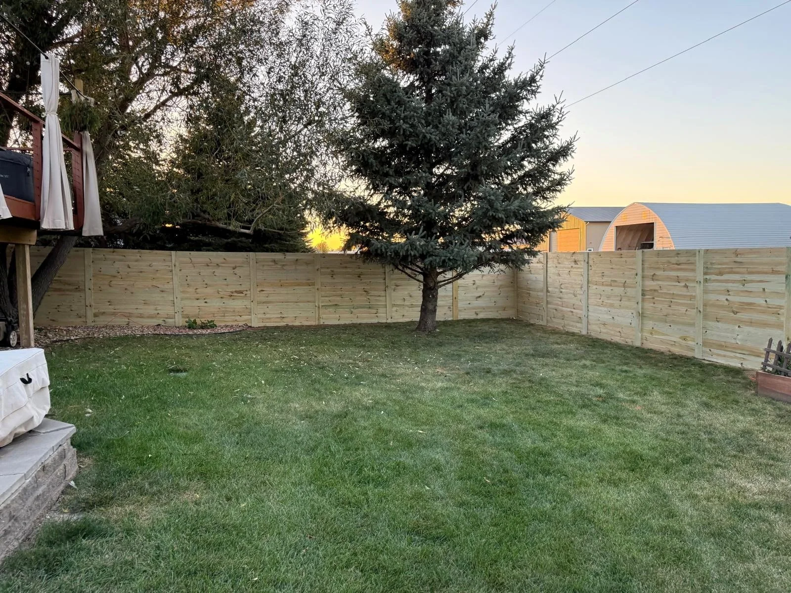 Full backyard enclosure with high-quality horizontal wood fencing.