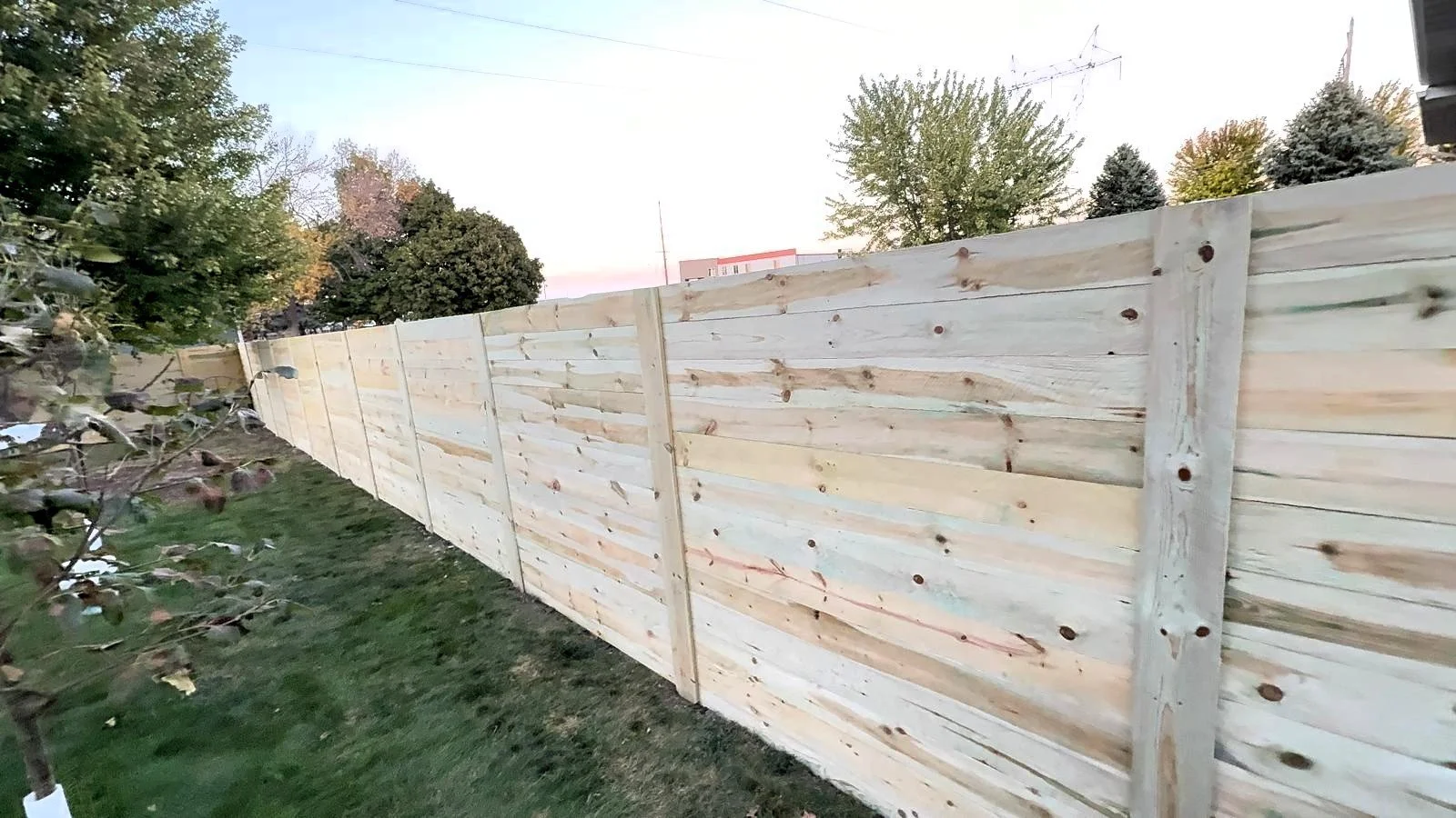 Modern horizontal cedar fence installation for local homeowners.