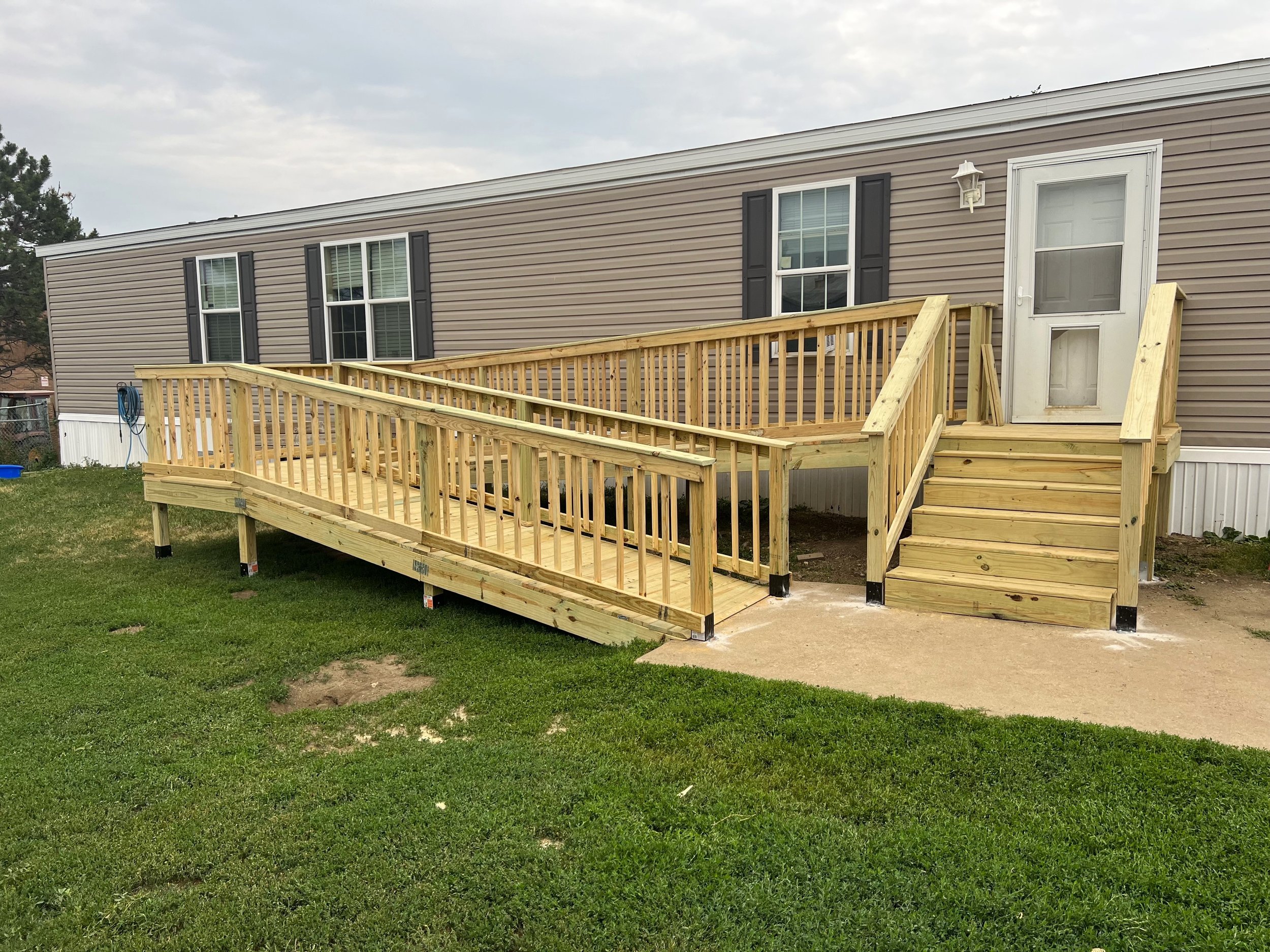 Long wood deck walkway attached to manufactured home in Sioux Falls