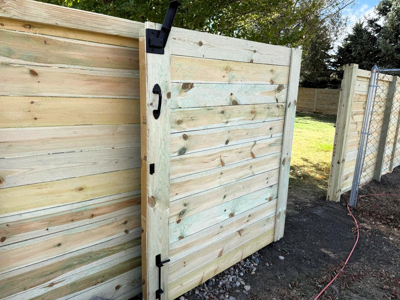 Open horizontal wood gate showing quality craftsmanship by AJ&D Contracting.