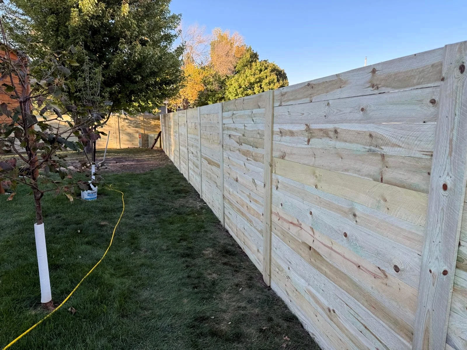 Side yard horizontal privacy fence installed by AJ&D Contracting.