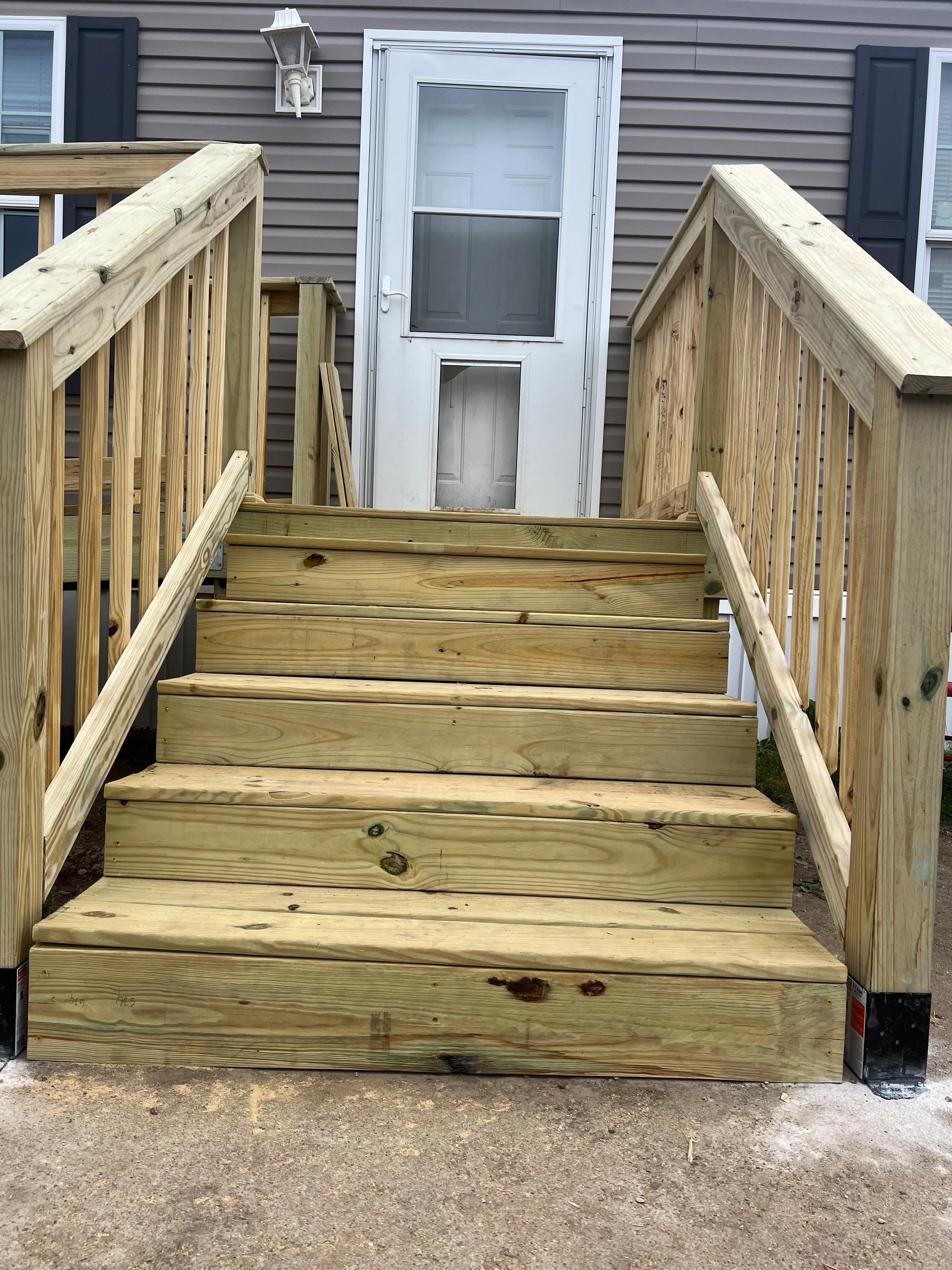 Wood deck stairs with landing and handrails built to code in Sioux Falls