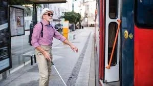 blind person getting on the bus