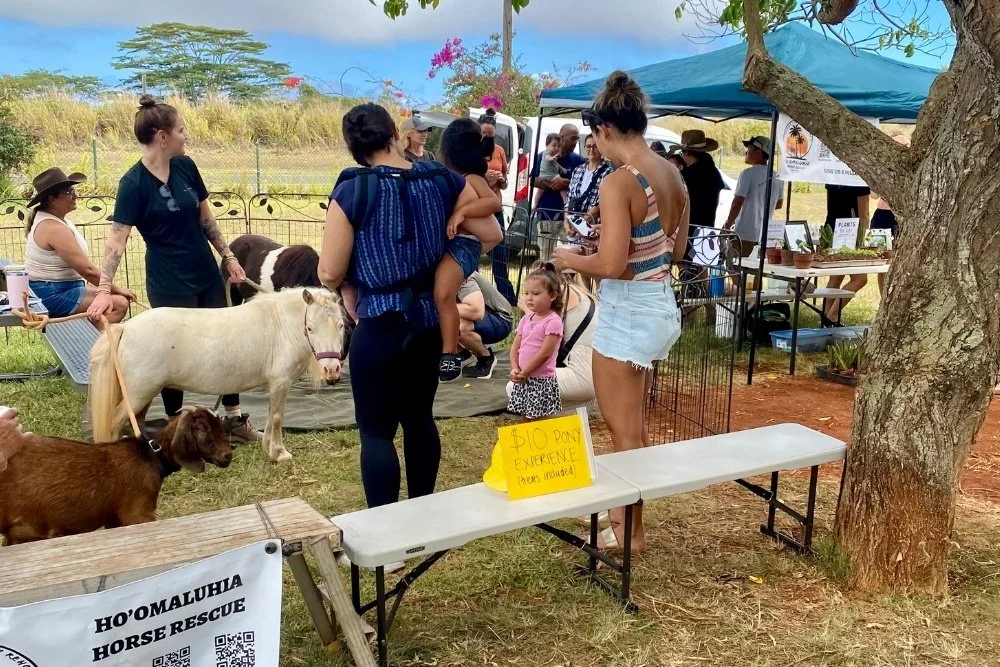 Family-friendly petting zoo at a local plant sale.